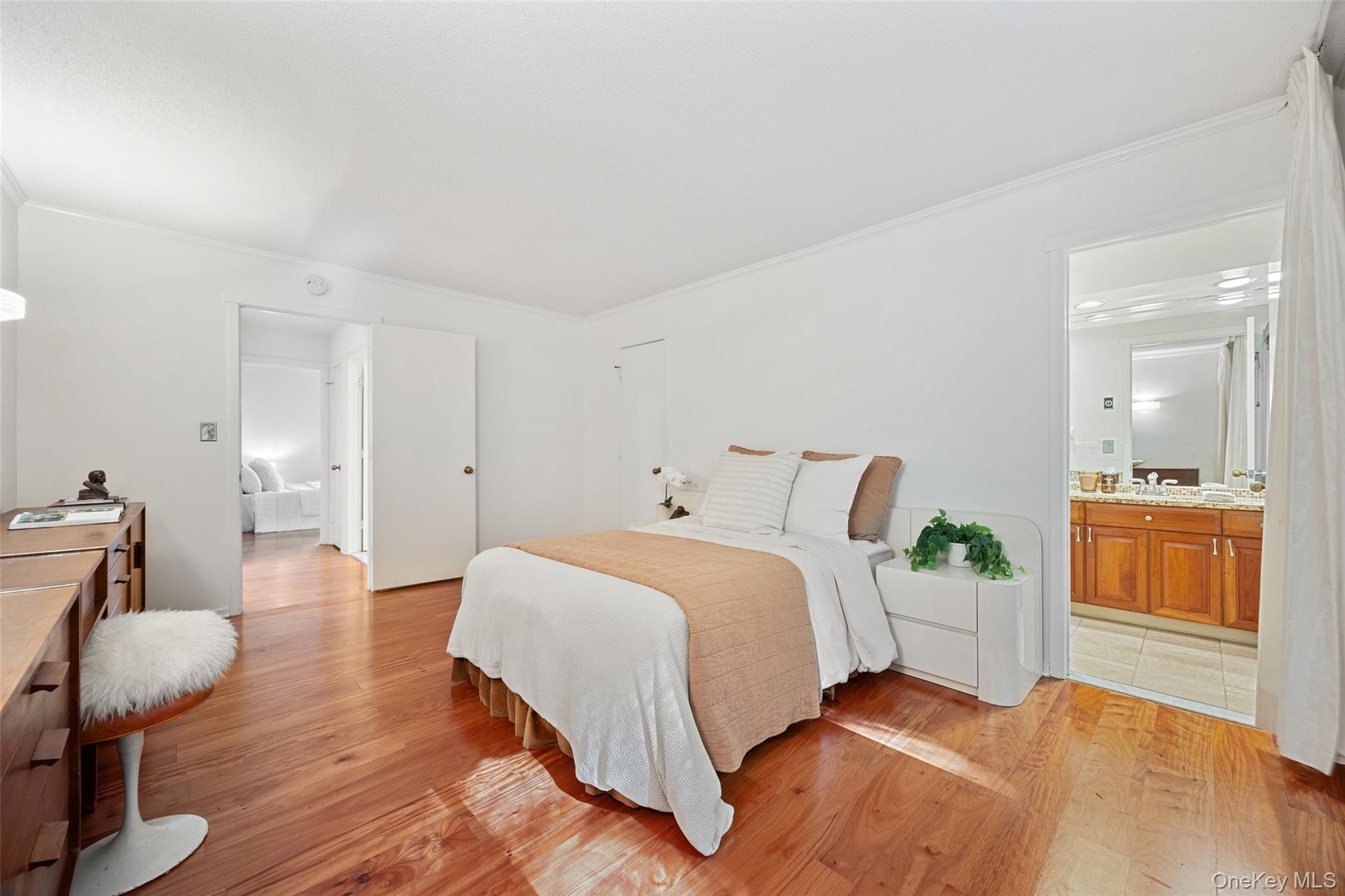 King-sized primary bedroom with large closet, ensuite bathroom, and additional exit to the private patio.