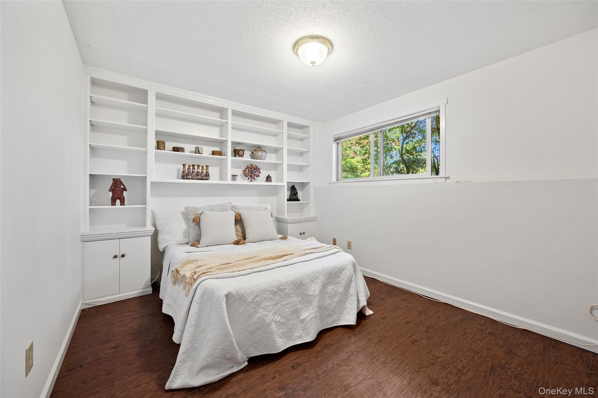 Finished lower level with built-in shelving works well as a den, office, or bonus room for guests.
