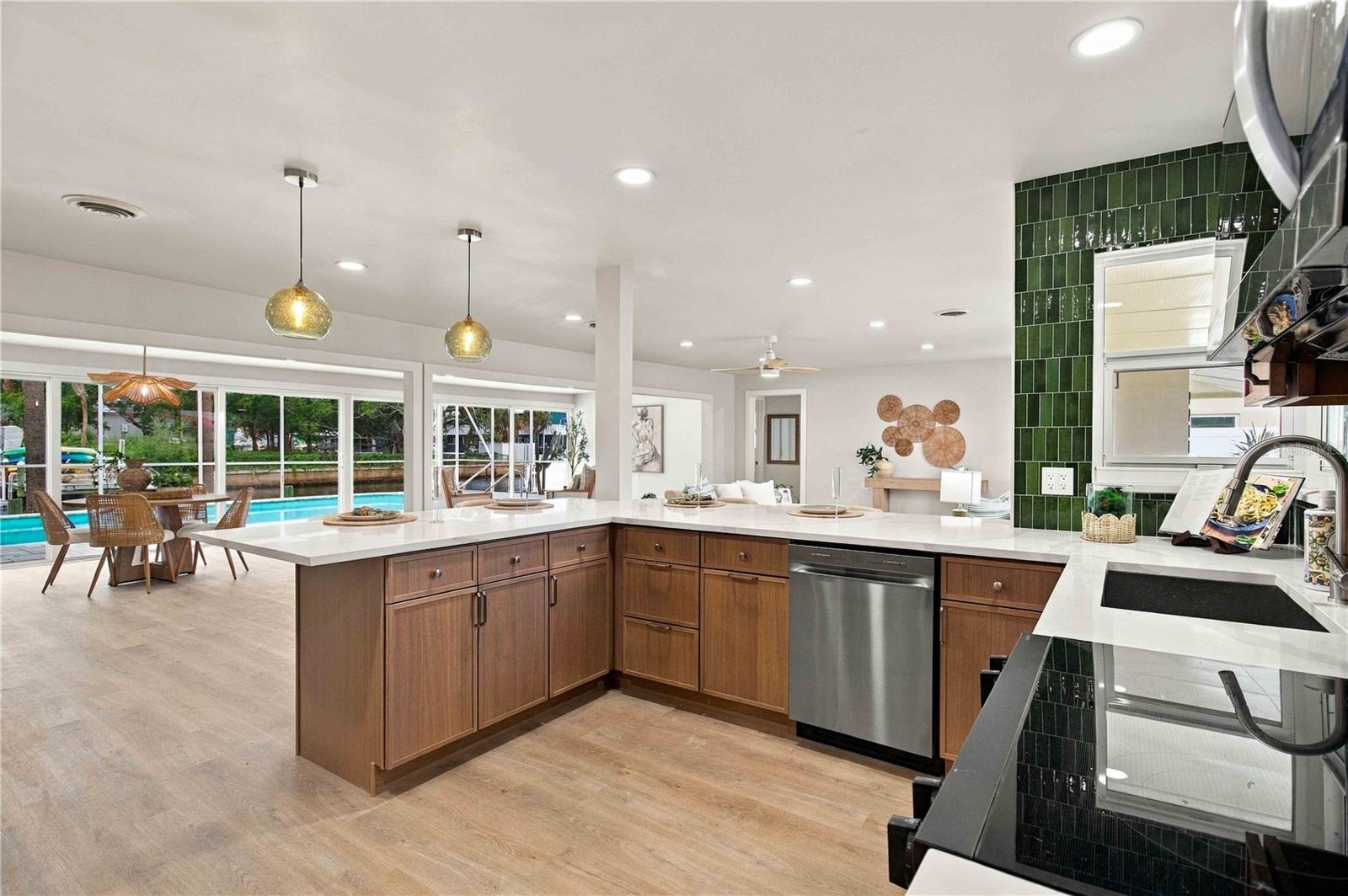 kitchen looking into the great room with views of the pool and canal.