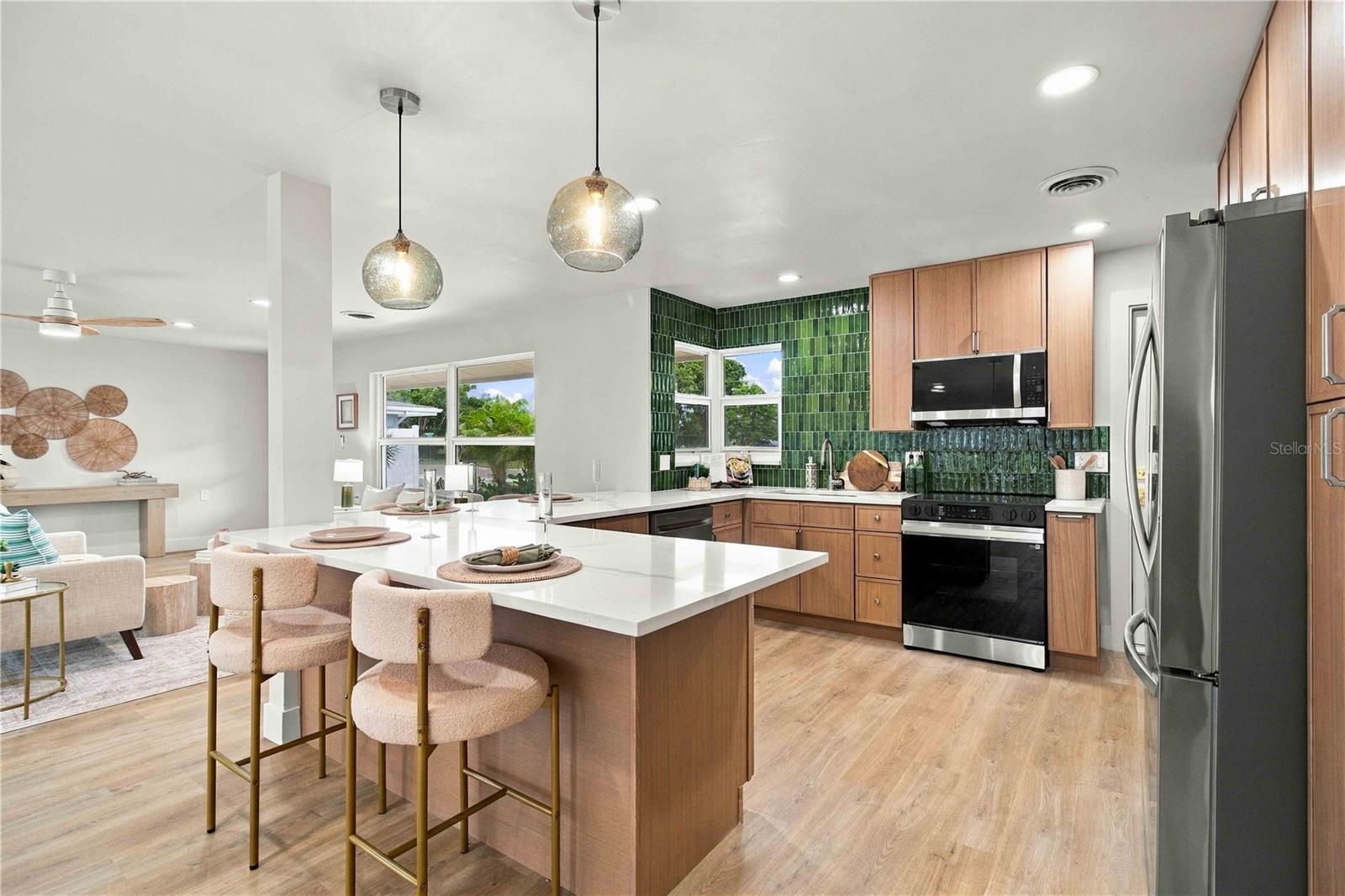 Open kitchen with quartz counters.