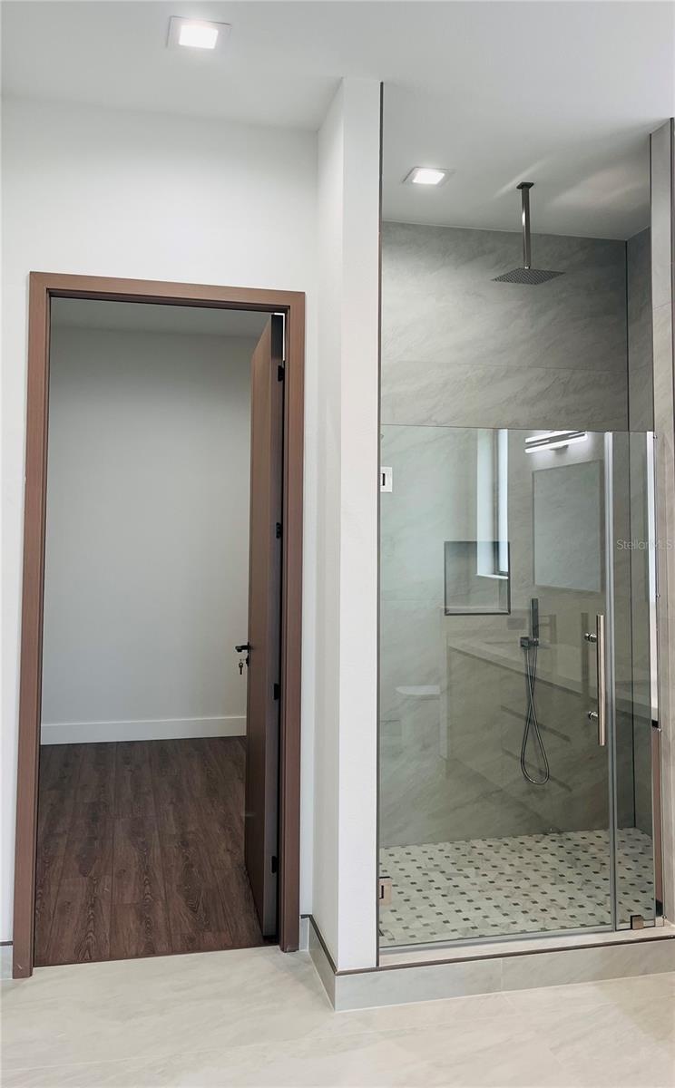 PRIMARY ENSUITE BATHROOM SHOWER W/HER WALK-IN CLOSET