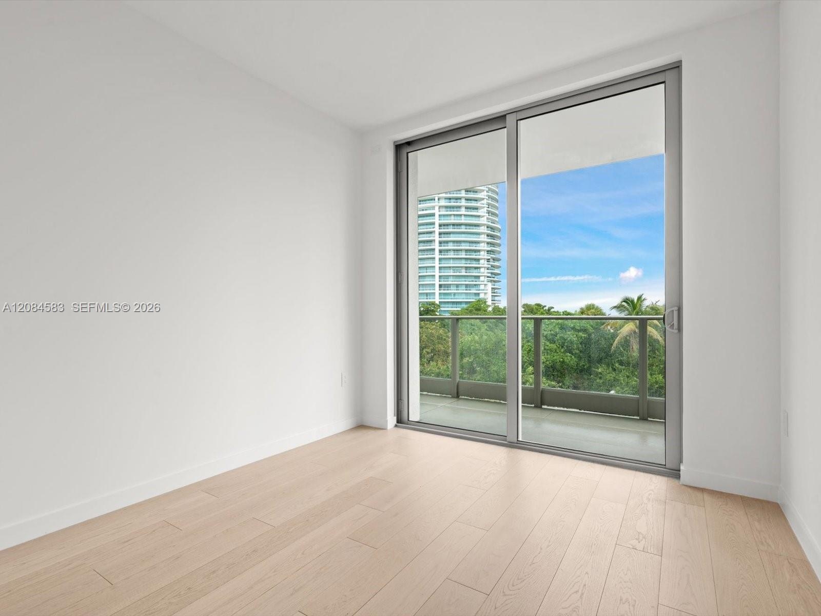 Bright secondary bedroom with floor-to-ceiling window