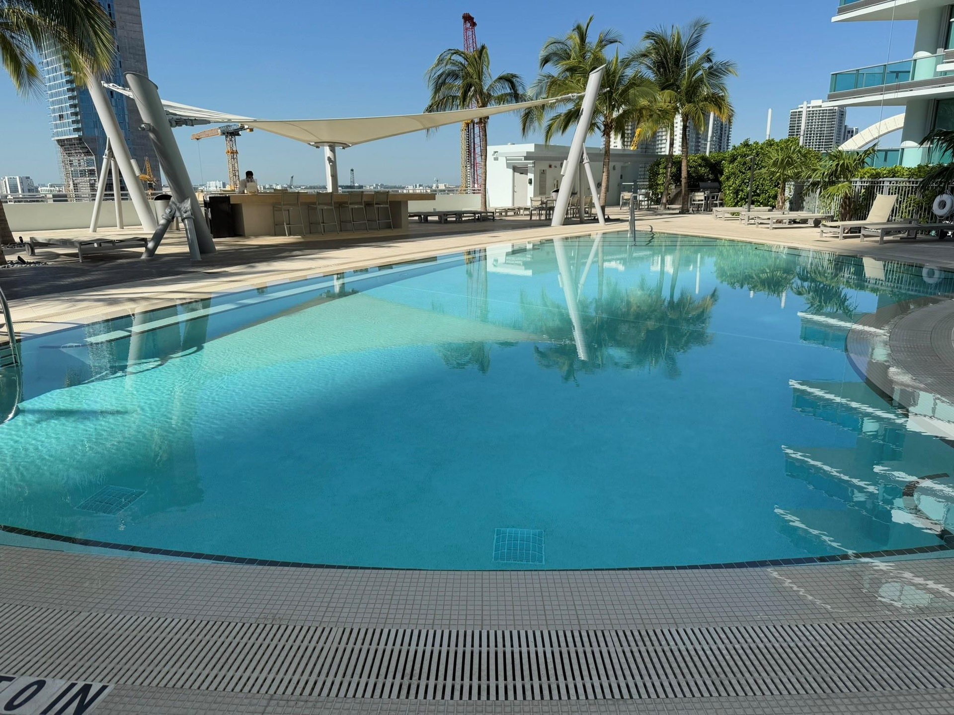 Expansive outdoor pool with integrated sun shelf