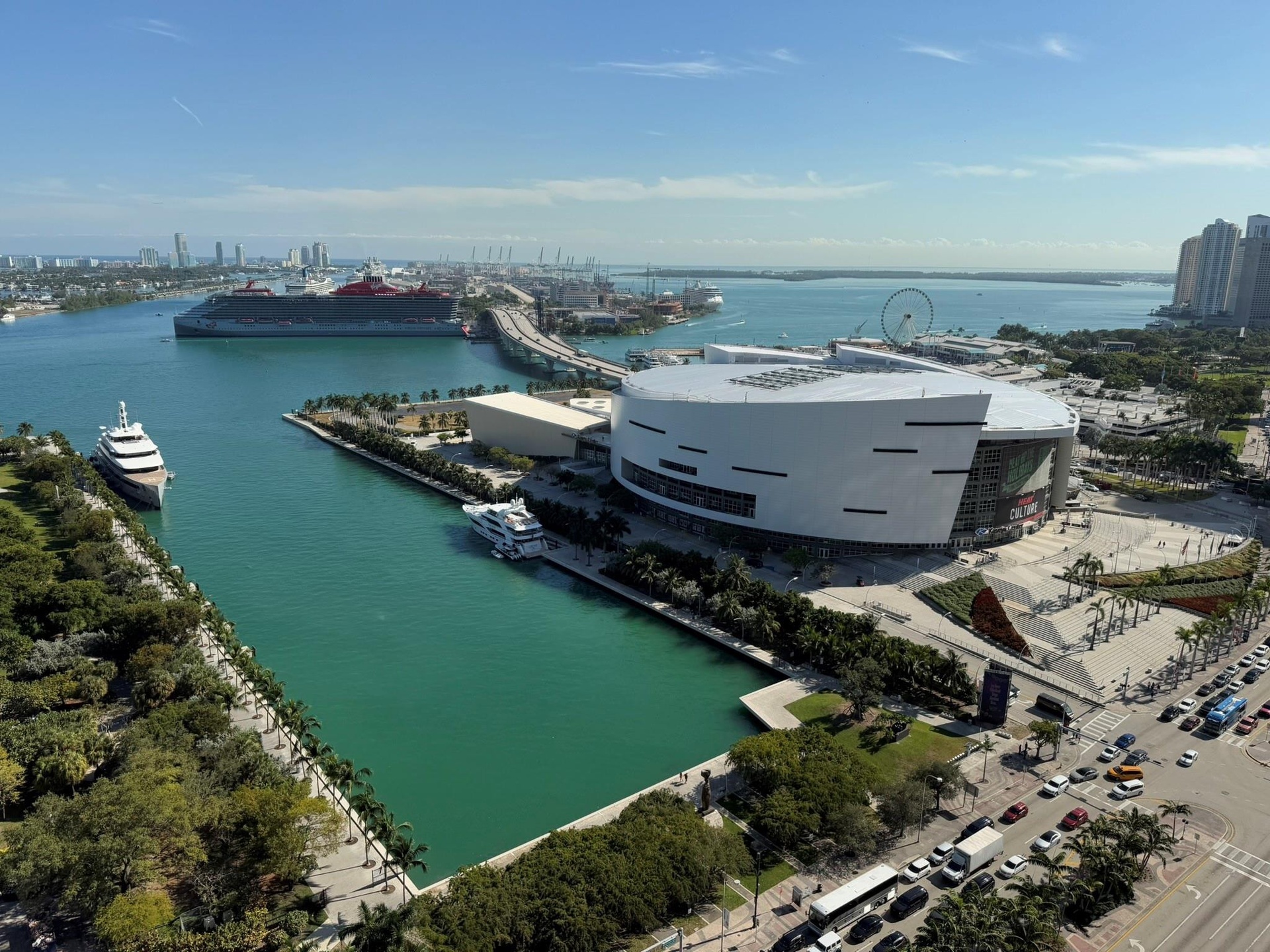 Aerial perspective showcasing a prominent waterfront arena with surrounding urban landscape