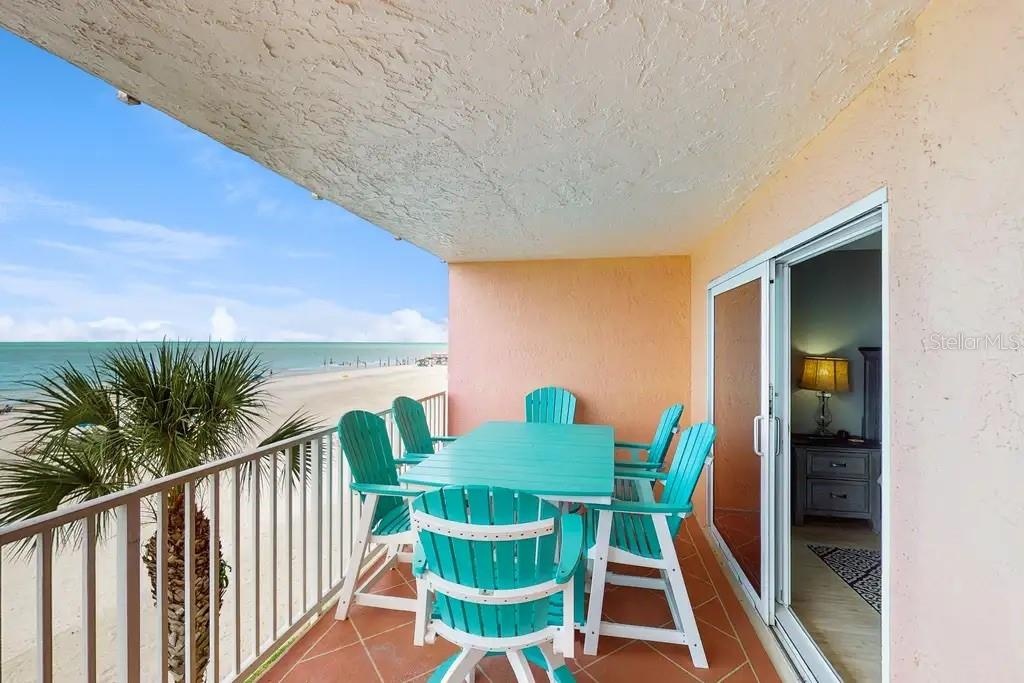 PRIVATE BALCONY OVERLOOKING THE BEACH, OFFERS DIRECT ACCESS FROM THE GREAT ROOM AND PRIMARY BEDROOM.