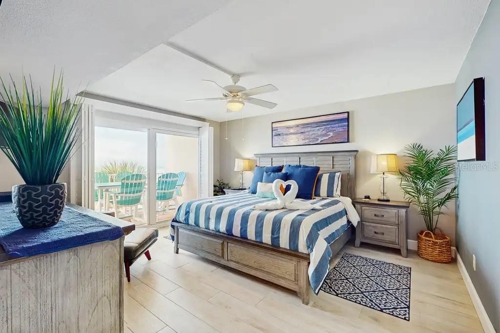 SPACIOUS PRIMARY BEDROOM OFFERS PRIVATE ACCESS TO YOUR BALCONY TO ENJOY THE SOUND OF THE WAVES FROM YOUR KING SIZE BED, ALSO FEATURES PLANTATION SHUTT