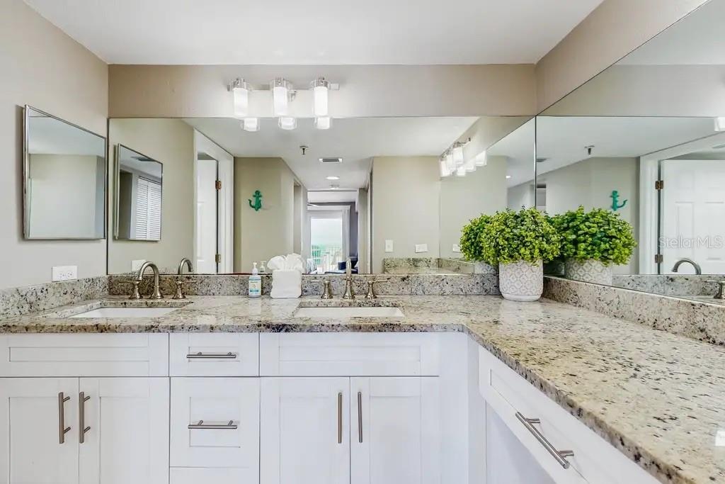 EN-SUITE BATHROOM WITH SEPARATE DRESSING AREA, DOUBLE SINKS, AND LARGE WALK-IN CLOSET WITH BUILT- IN WARDROBE ORGANIZERS COMPLETES THE SPACIOUS PRIMAR