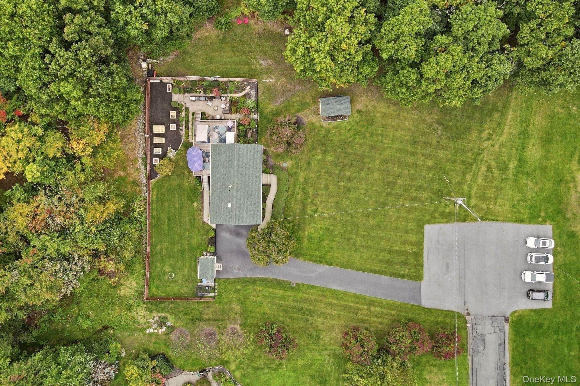 A wider perspective highlights the home's setting and surrounding grounds.