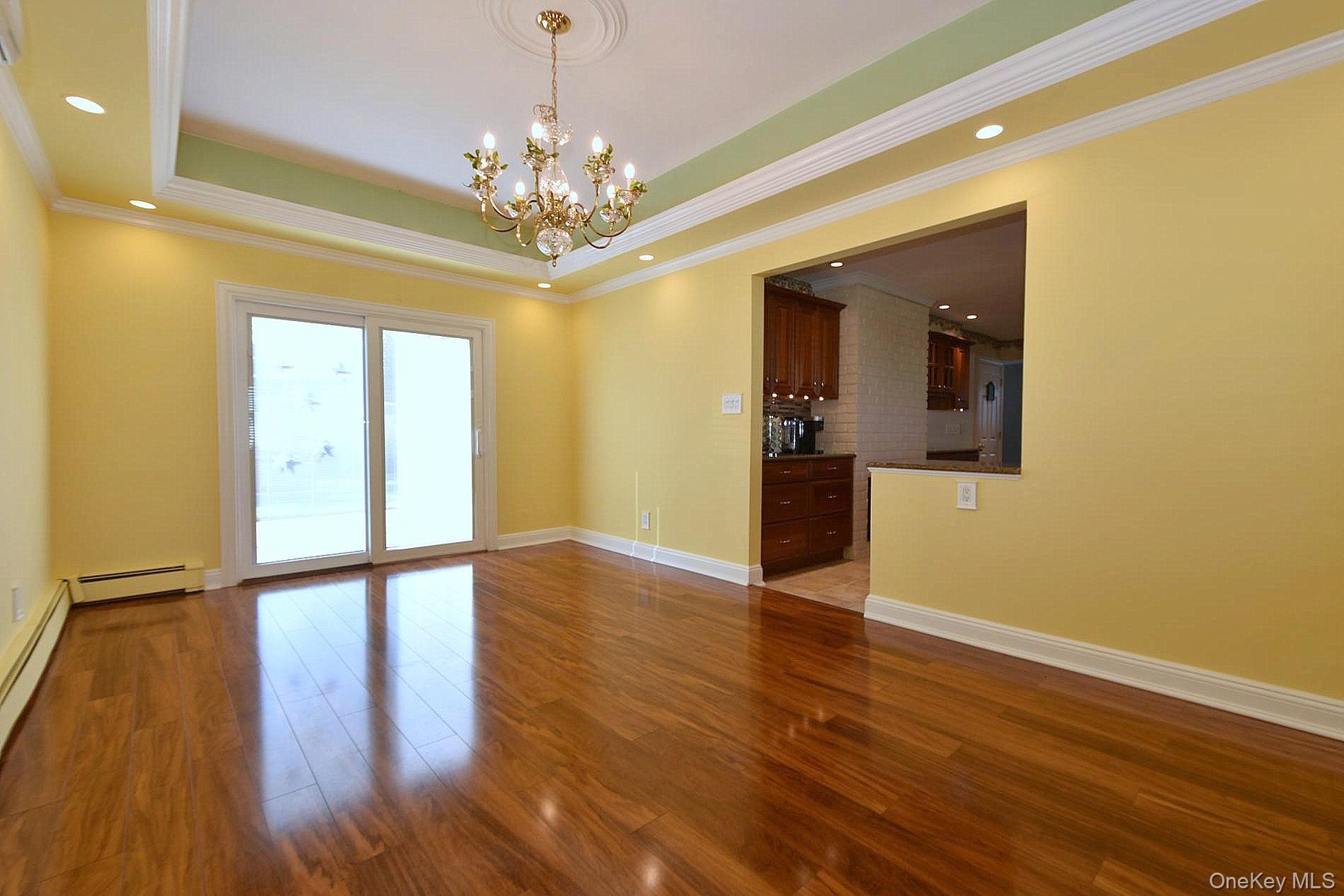 Dining Room with a tray ceiling & sliding door to the back yard.