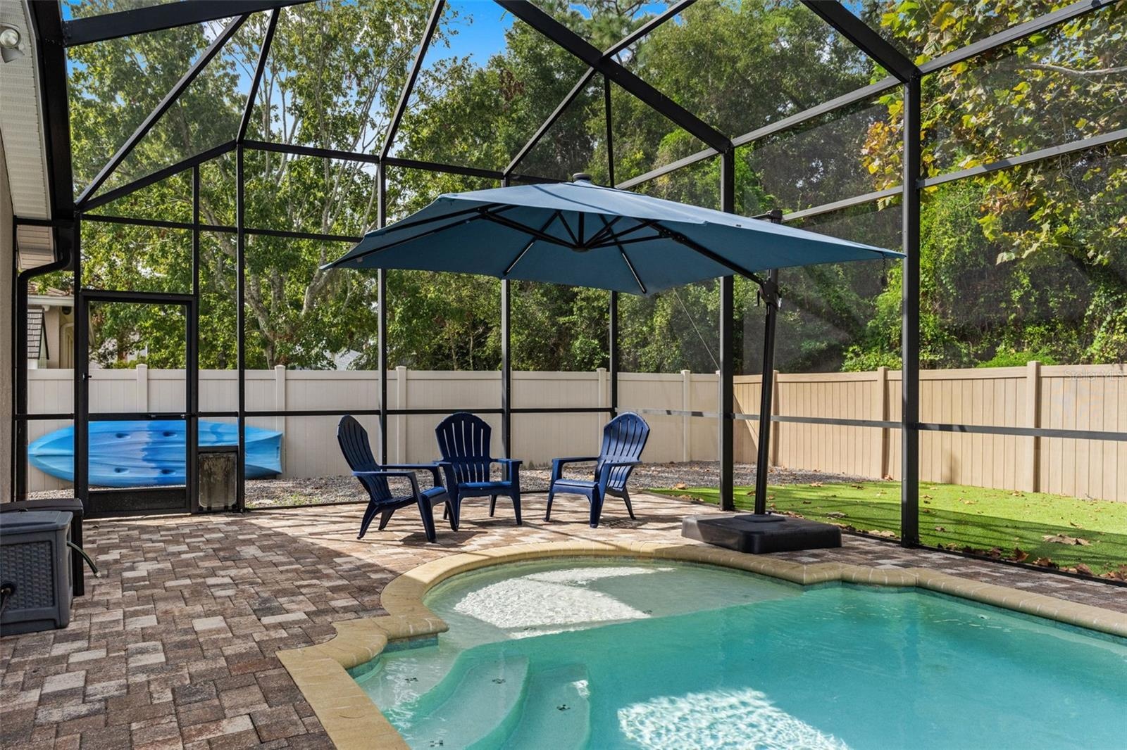 Sun or shade? There’s room for both, with open poolside space complemented by a large umbrella-covered seating area.