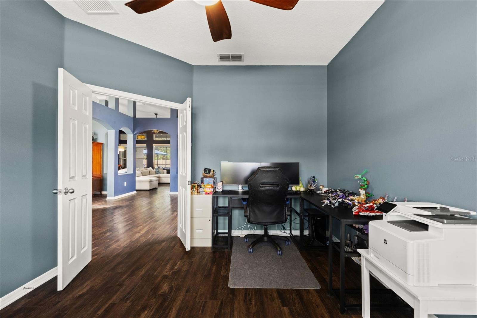 French doors allow the den to be closed off when needed—ideal for an office, study, hobby room, or quiet retreat.