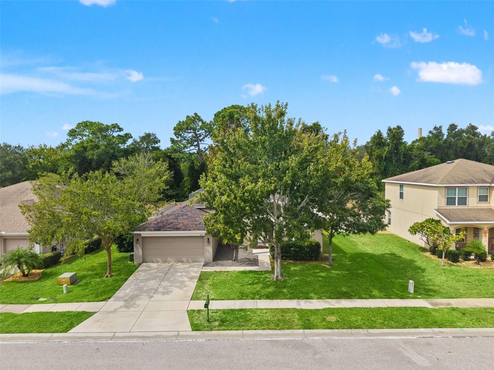 From above, the home’s single-story design, mature landscaping, and established Gulfwinds setting come into view.