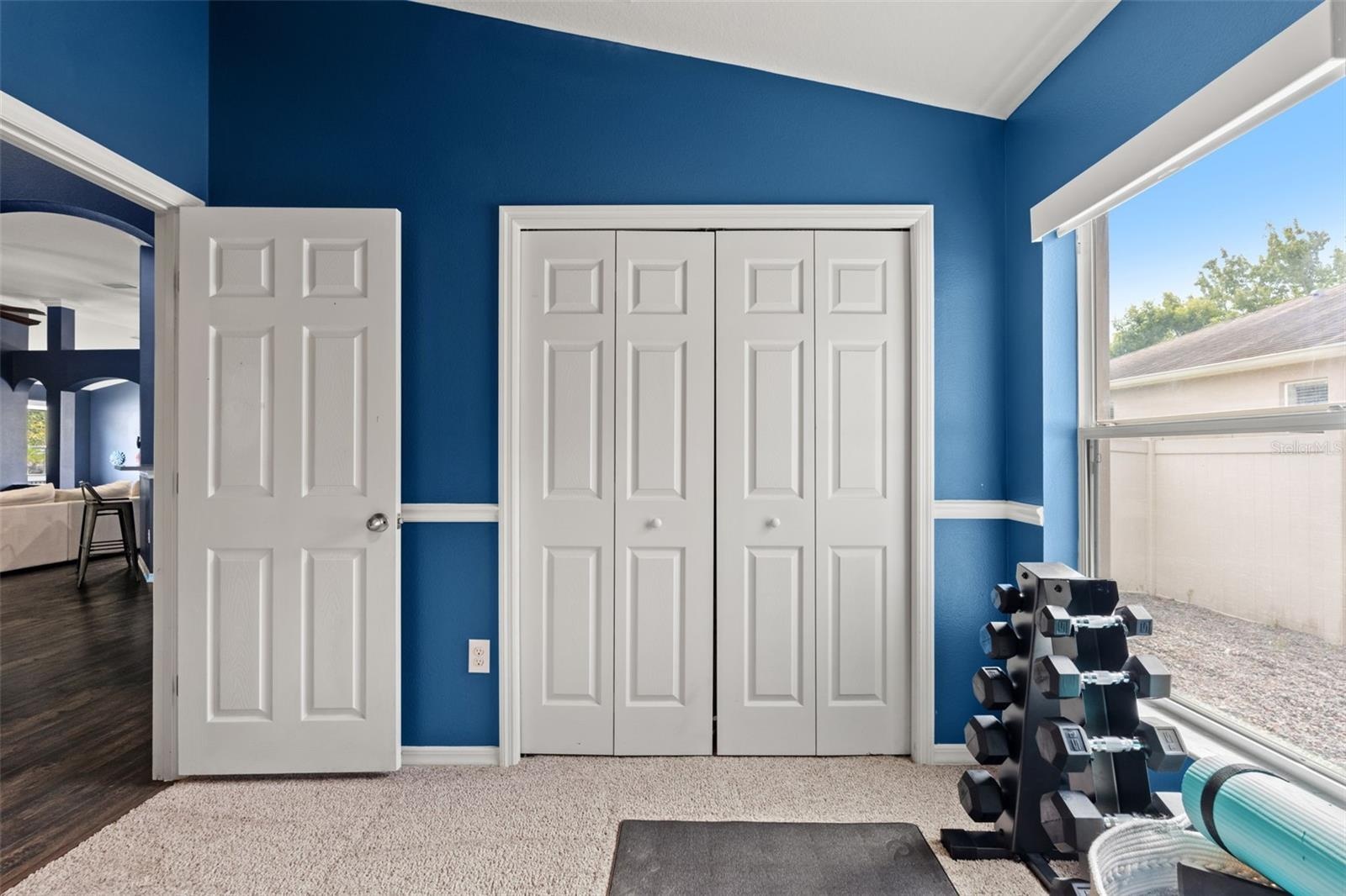 Natural light and a full closet make this flexible room equally well suited as a bedroom, fitness room, or hobby space.