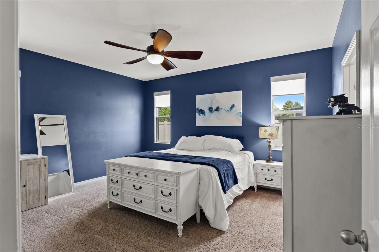 The spacious primary suite offers plenty of room for substantial furniture while maintaining a comfortable, uncluttered feel.