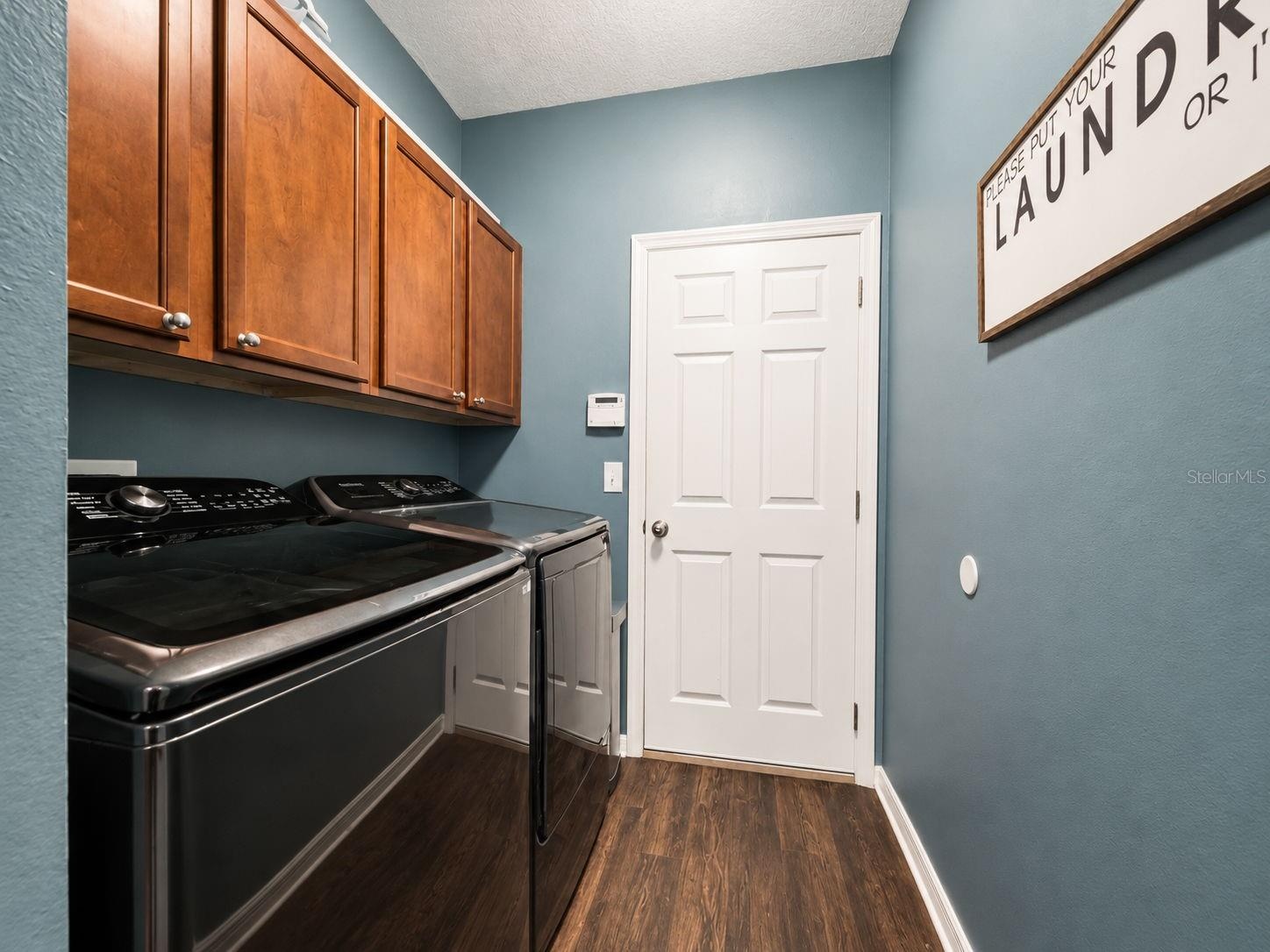 The conveniently located laundry room provides additional cabinetry and direct access to the garage.