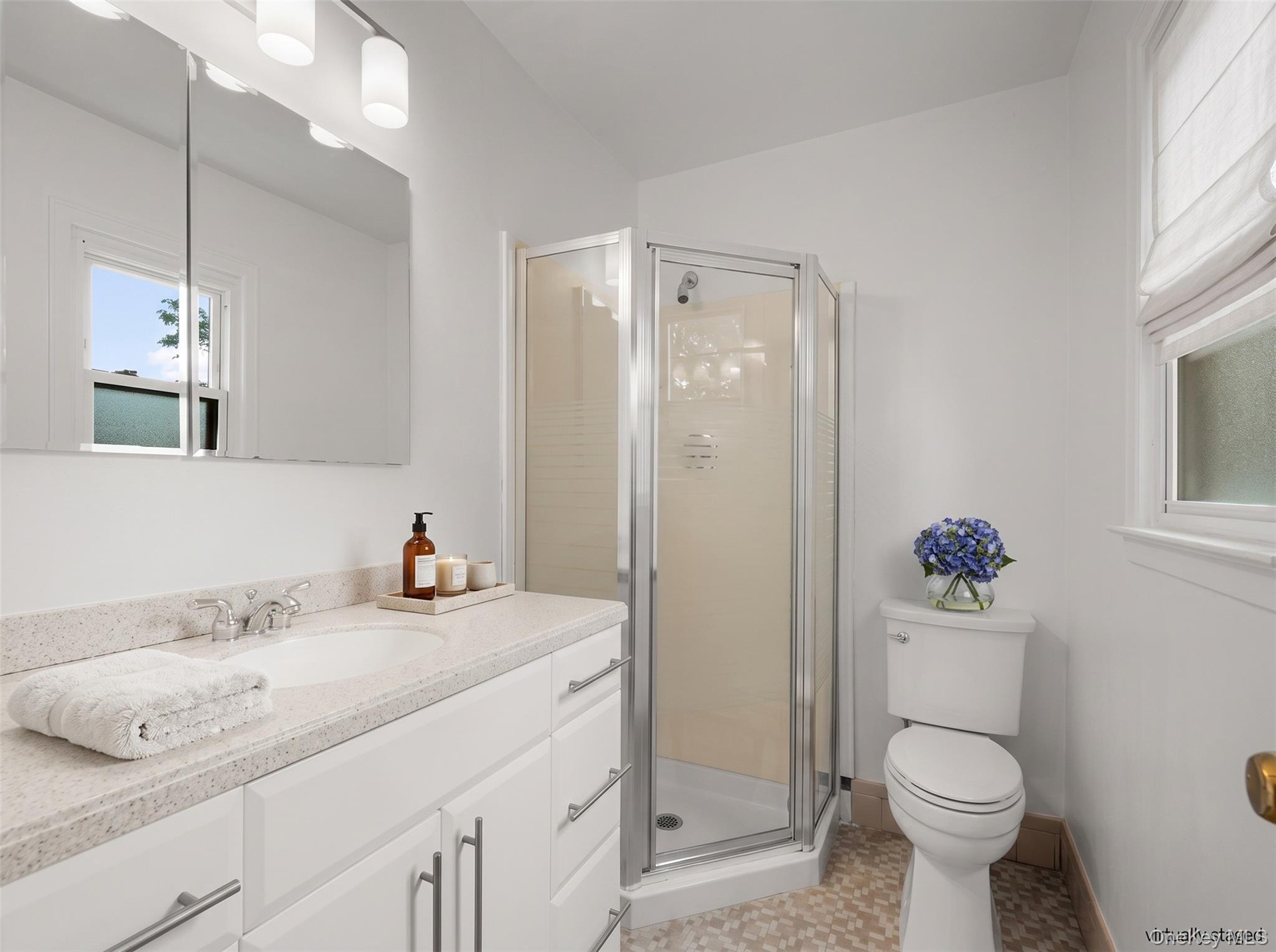 A private en-suite bathroom with stall shower.