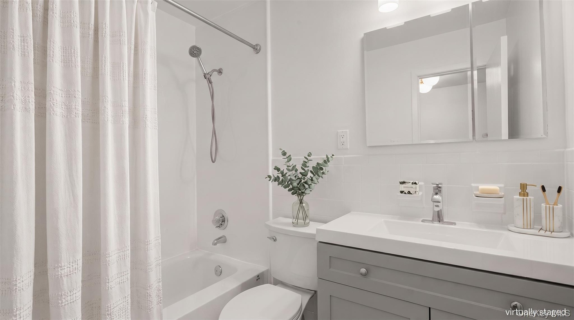 Refreshed hall bath features a modern vanity and updated fixtures.