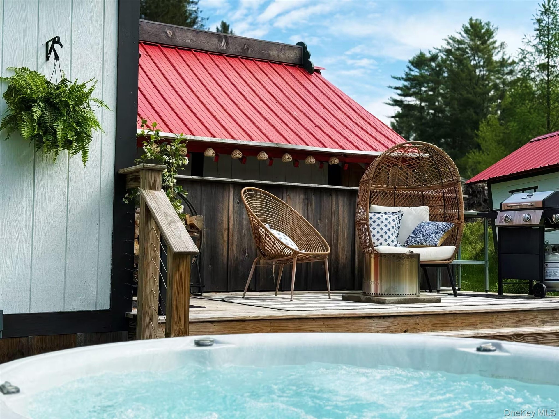 round hot tub off the deck by the waterfall