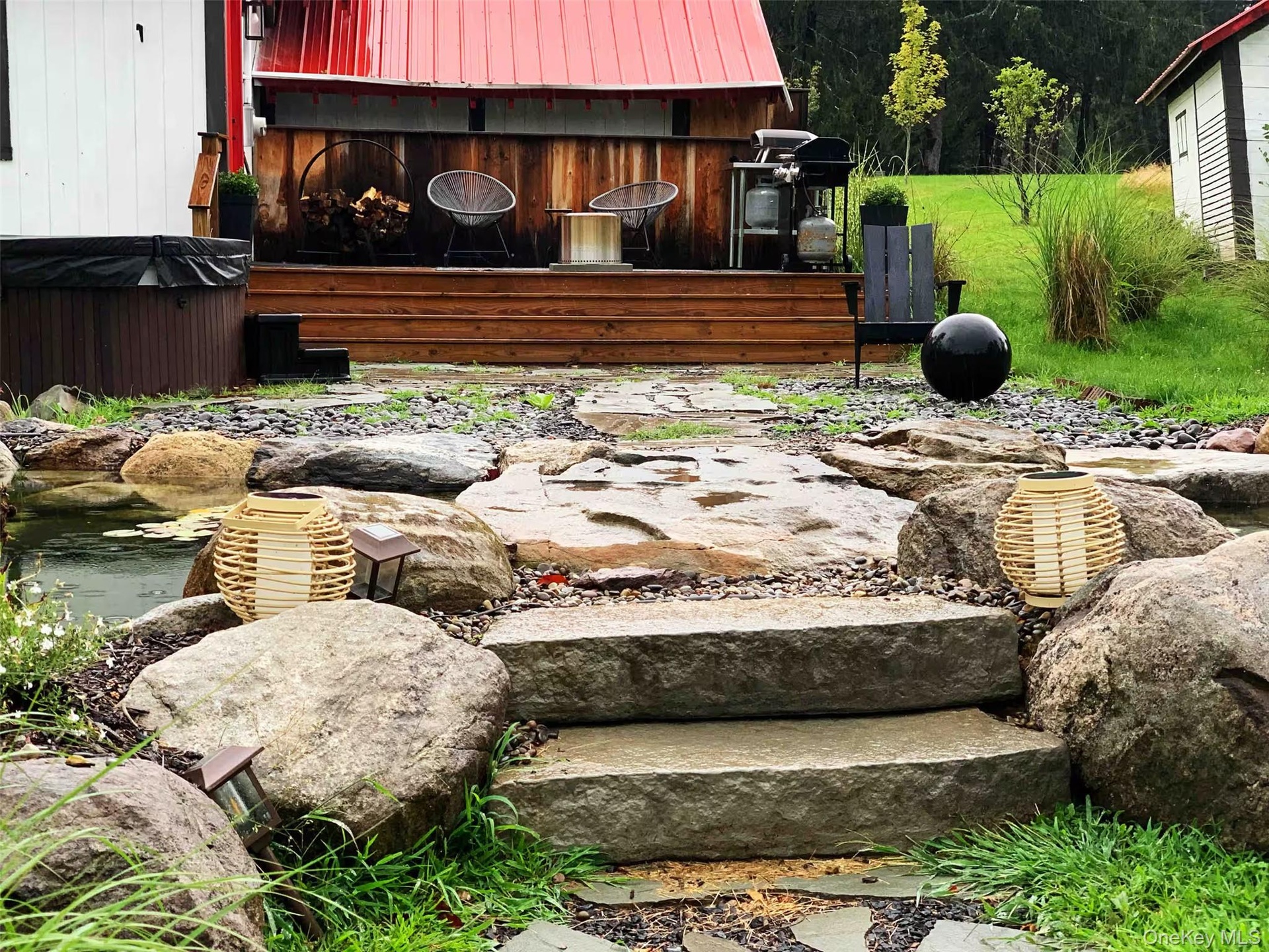 Waterfall pond with stone bridge greets you as you walk into the home