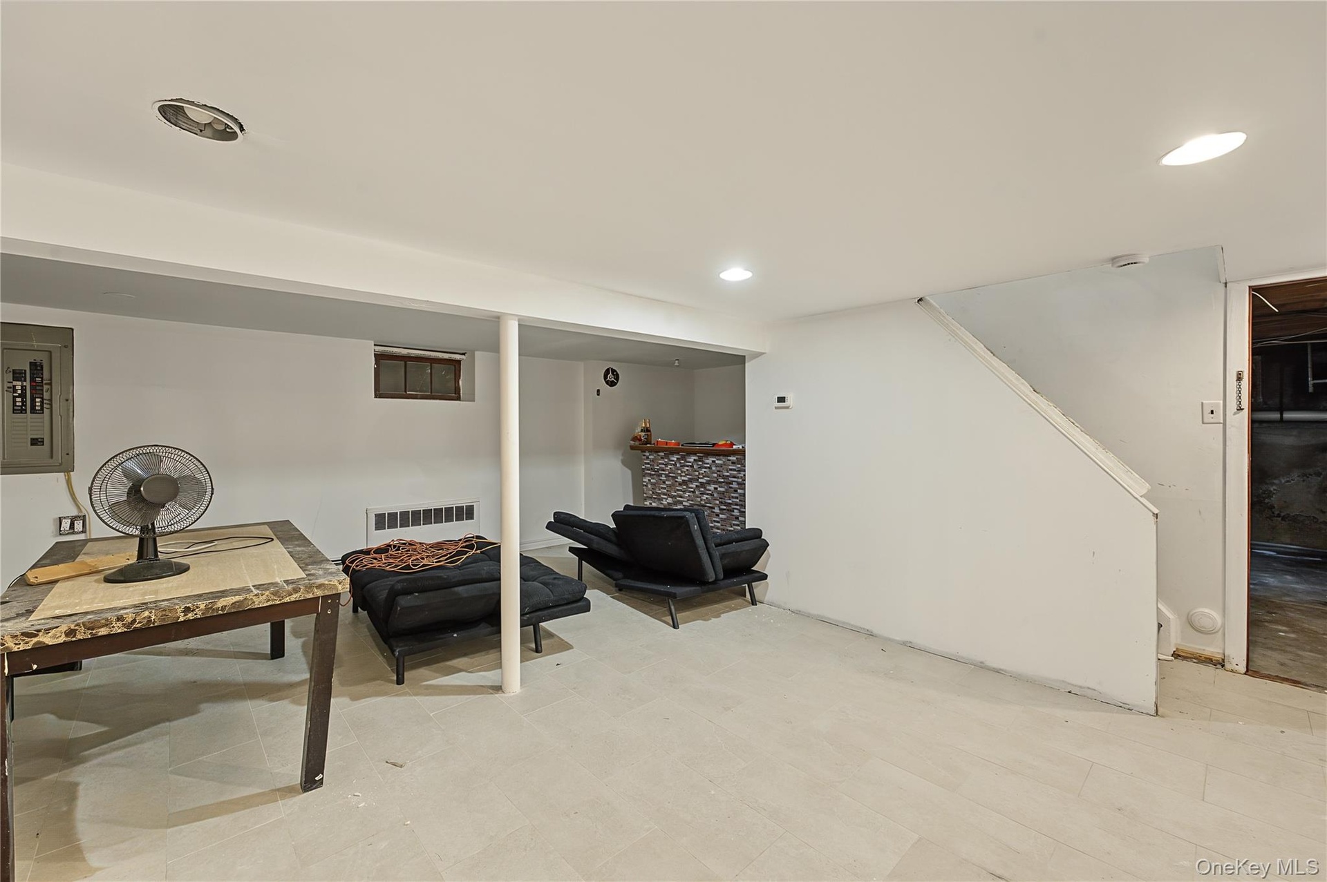 Finished lower level space featuring recessed lighting, holds endless possibilities with its  tile flooring