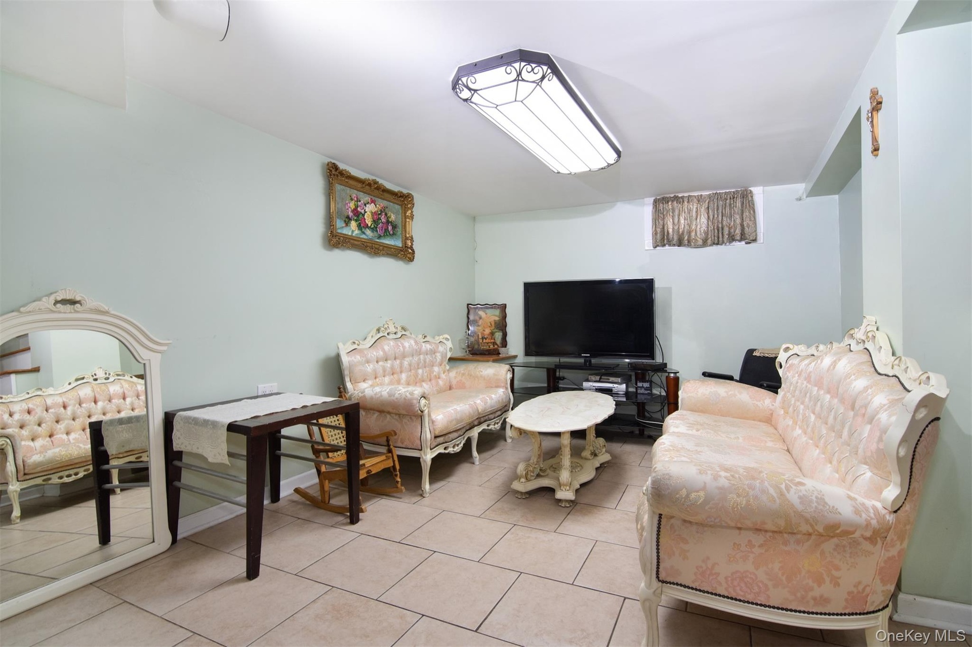 Tiled lower level Family Room with 1/2 bath and Utility Room