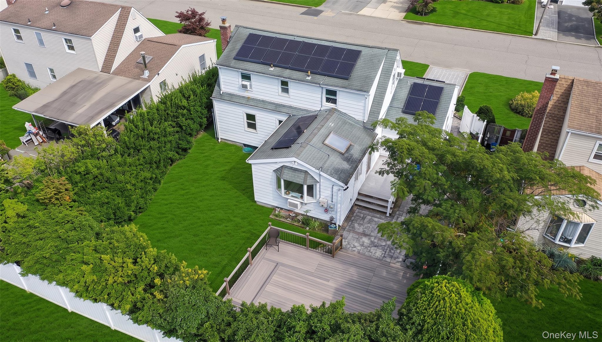 Expansive backyard with a composite deck, and mature privacy landscaping
