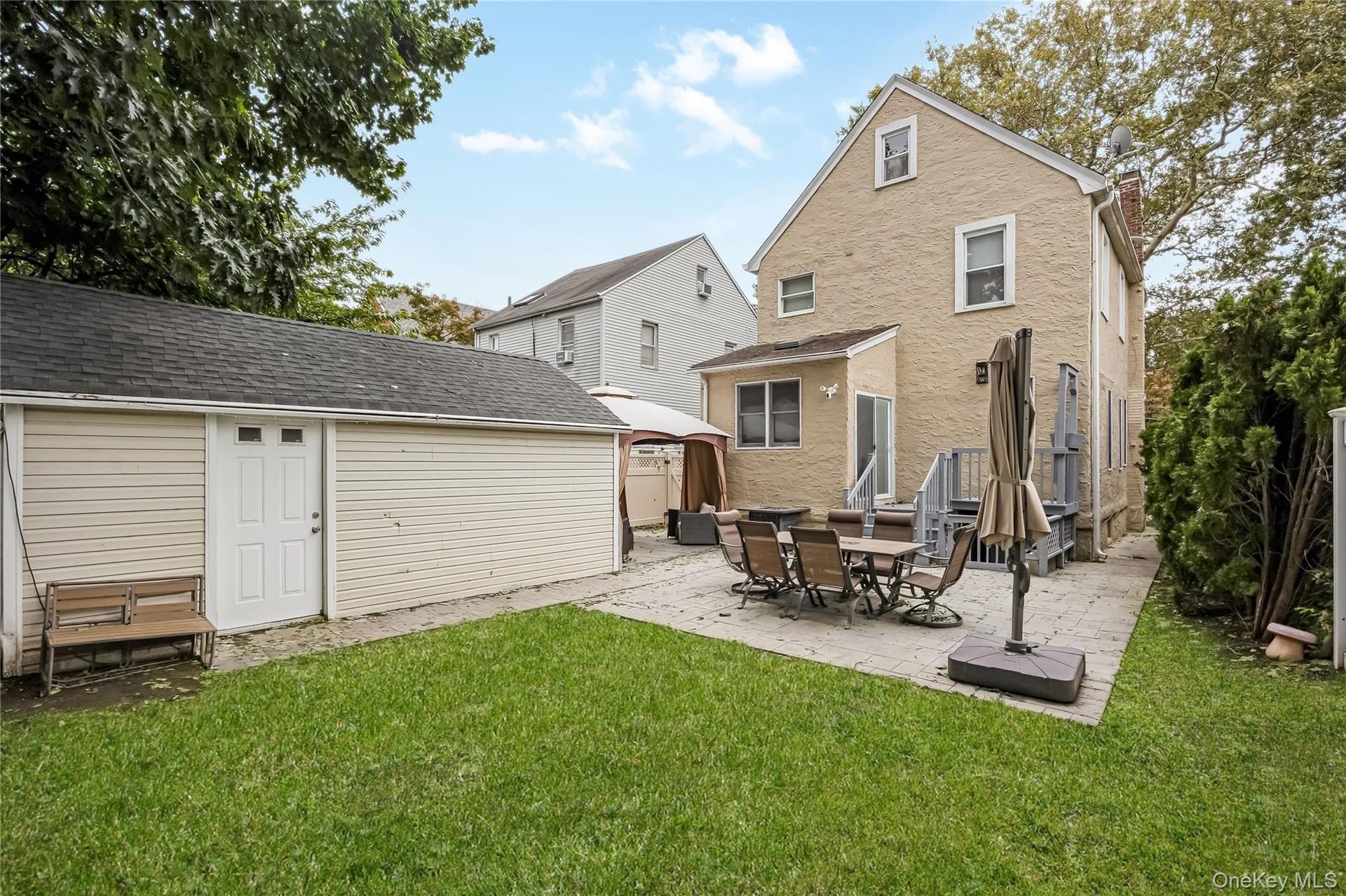 Backyard with Patio and 1-car detached garage.