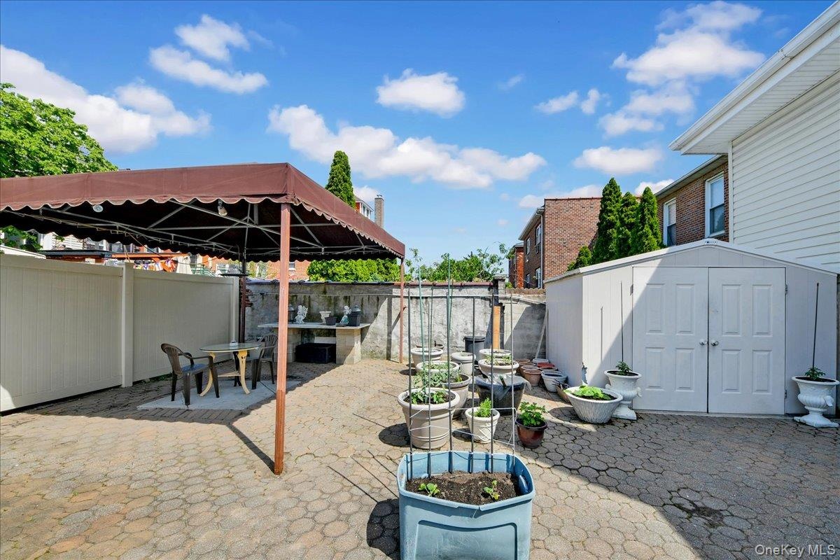 Rear yard finished with pavers and covered patio