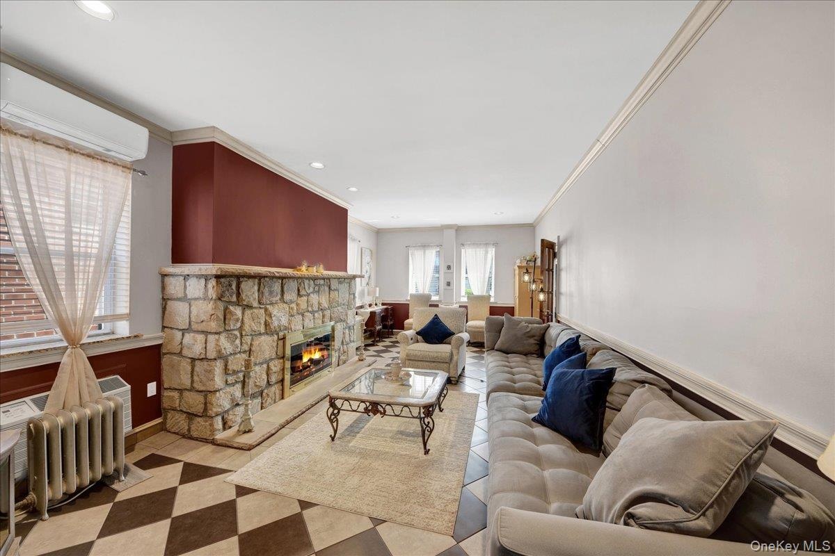 generous living room with wood burning stone fireplace