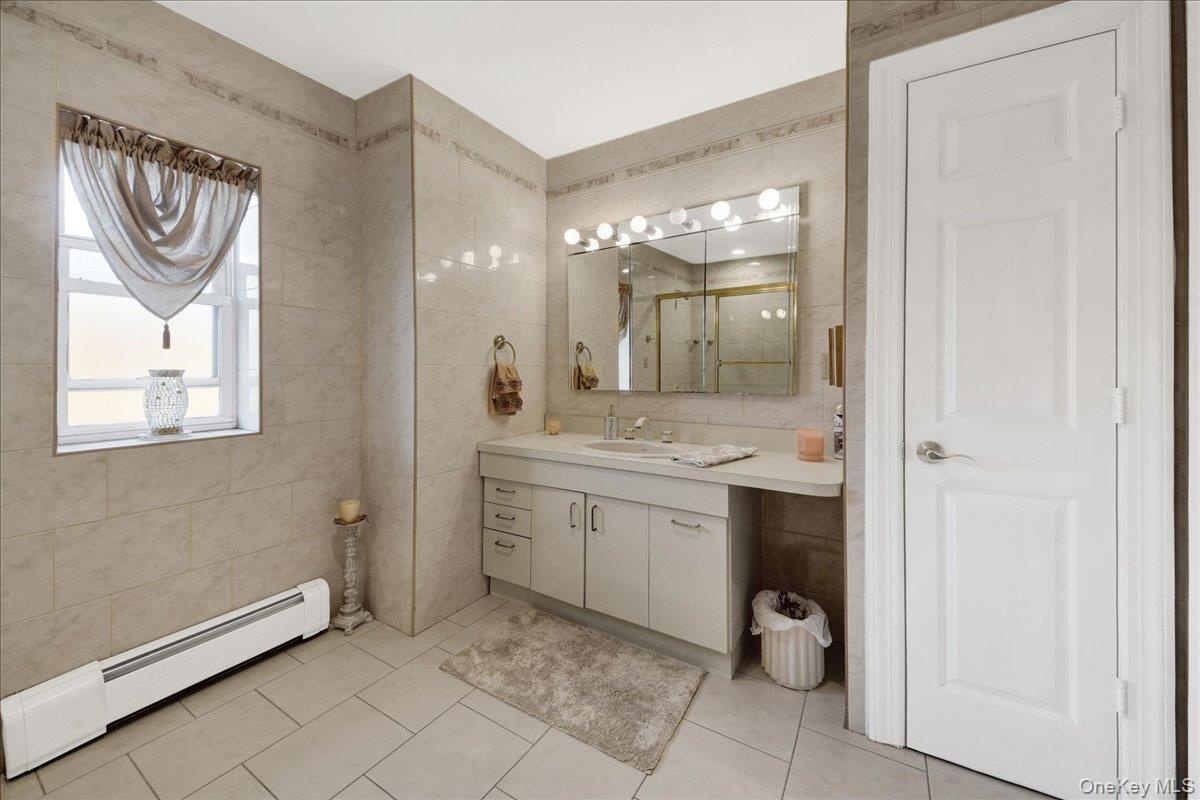 Grand spa full bath with linen closet on second floor