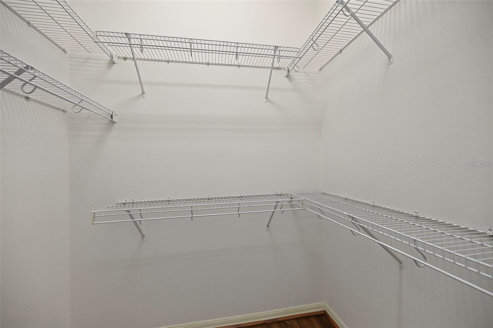 One of two walk-in closets in primary bedroom