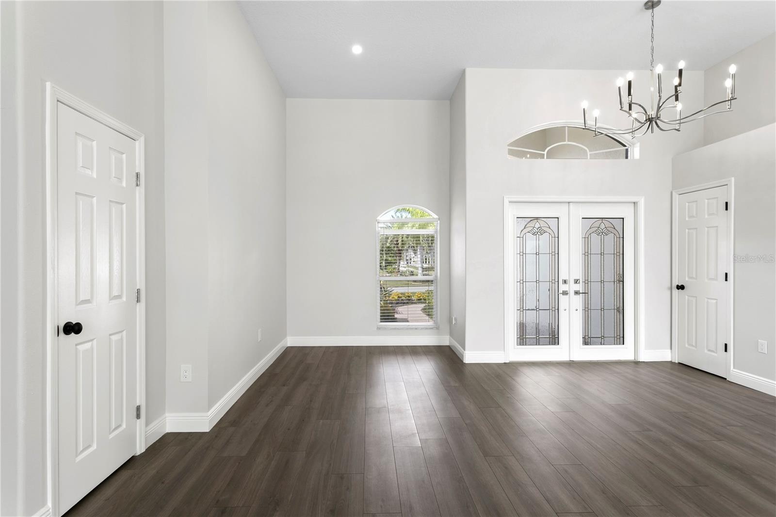 Welcoming double-door entry with beautiful lighting, ample storage and elegant laminate flooring carried throughout the home