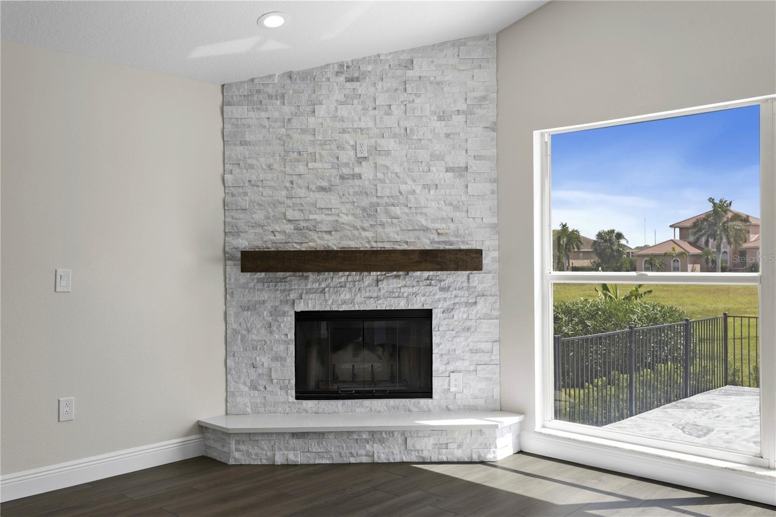 Beautiful wood-burning fireplace with elegant mantel and tile surround - a charming touch of character.