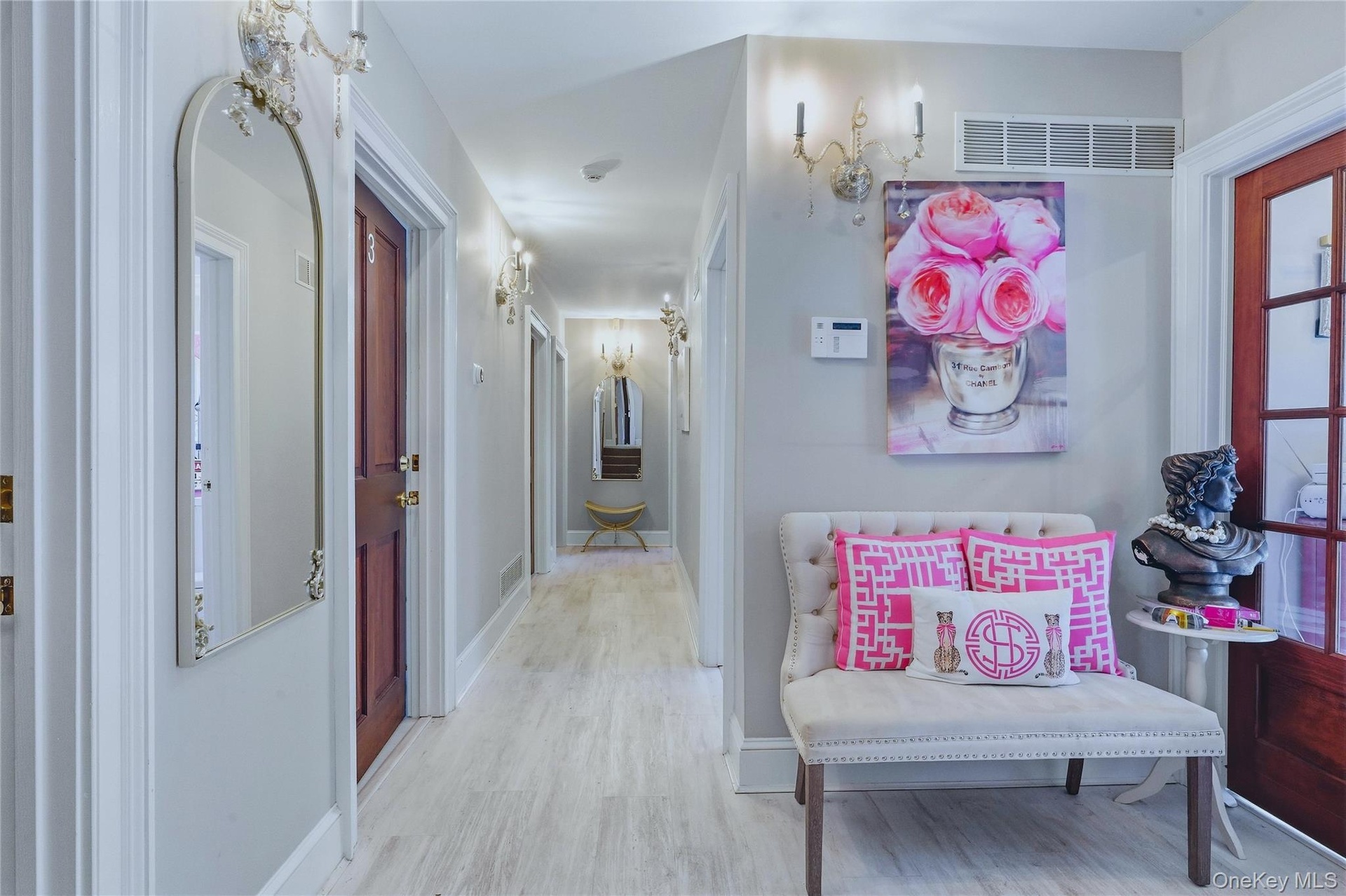 Light wood-finish flooring extending through the hallway