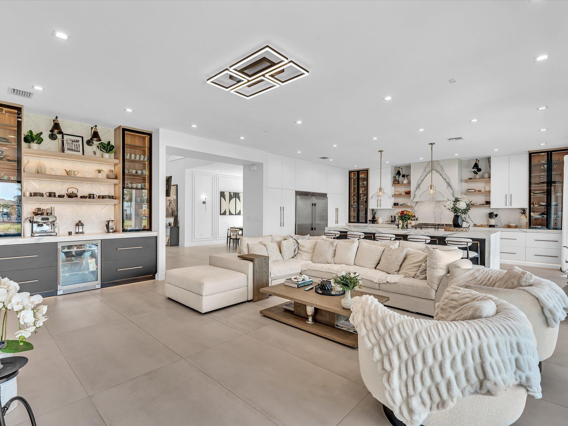 Spacious living area featuring clean modern finishes, recessed lighting, and seamless flow to the kitchen and dining spaces.
