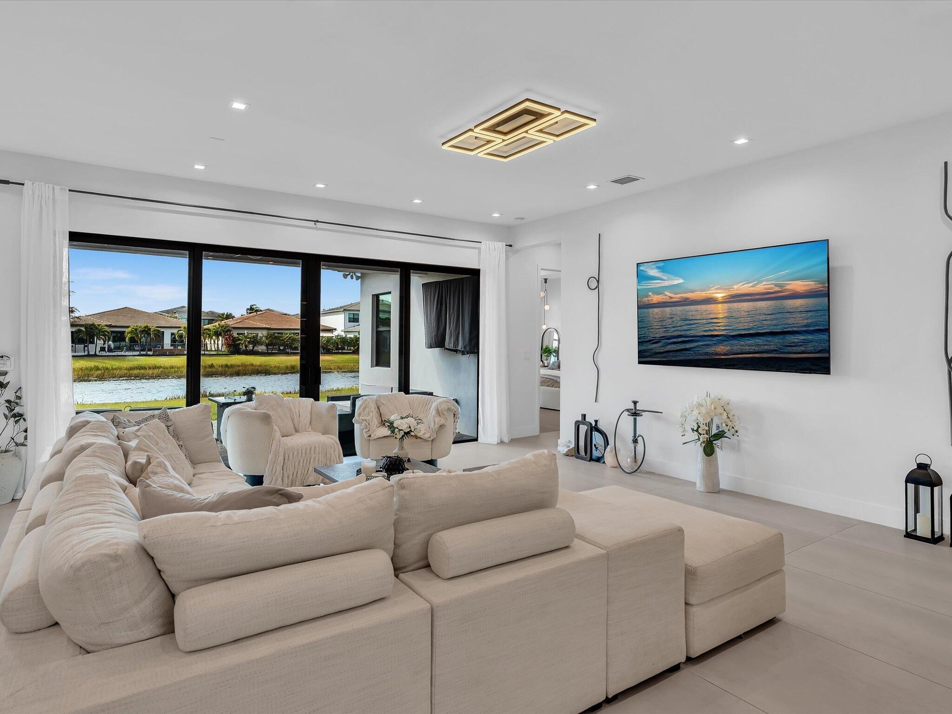 Spacious living area featuring clean modern finishes, recessed lighting, and seamless flow to the kitchen and dining spaces.