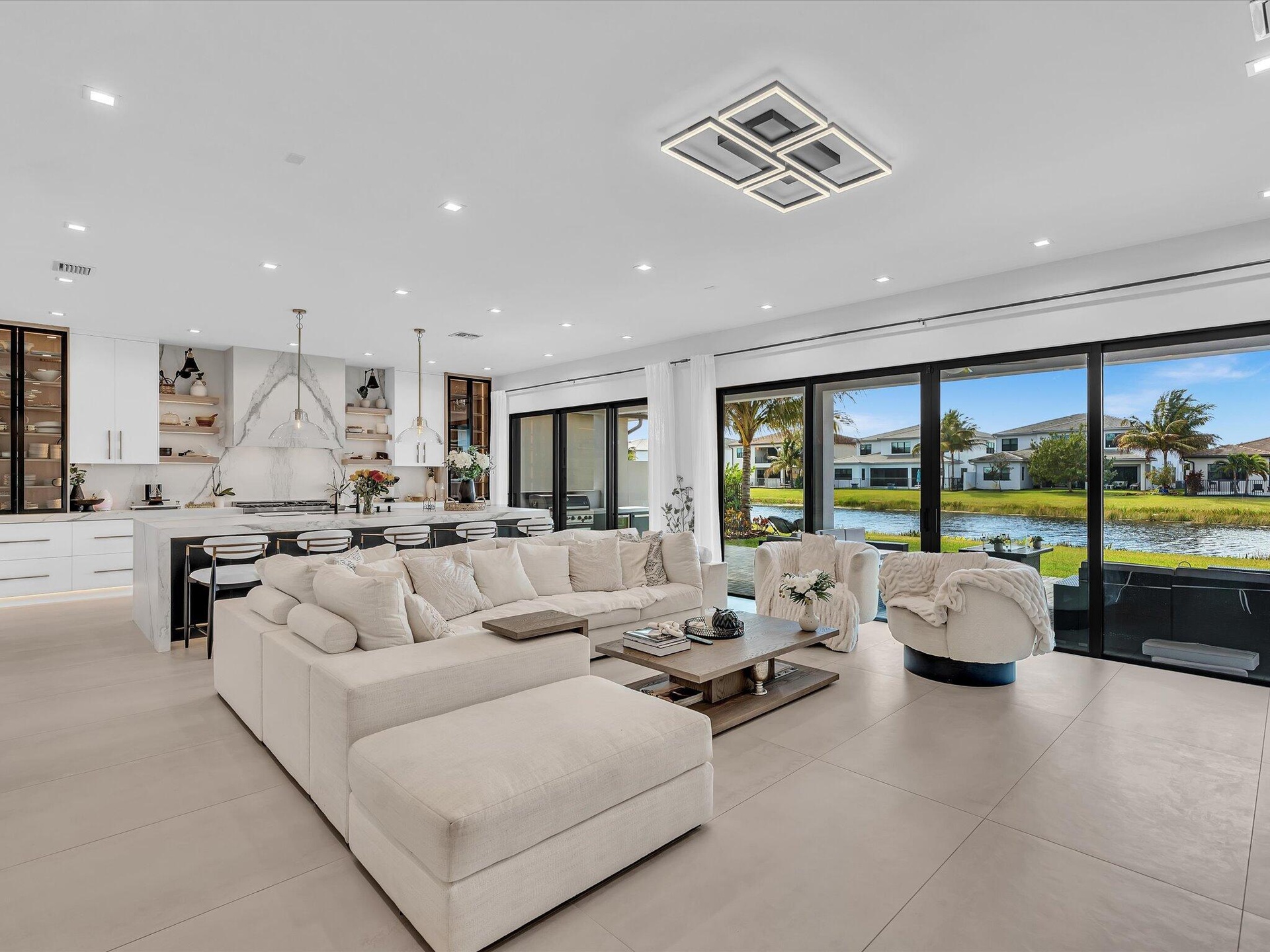 Spacious living area featuring clean modern finishes, recessed lighting, and seamless flow to the kitchen and dining spaces.