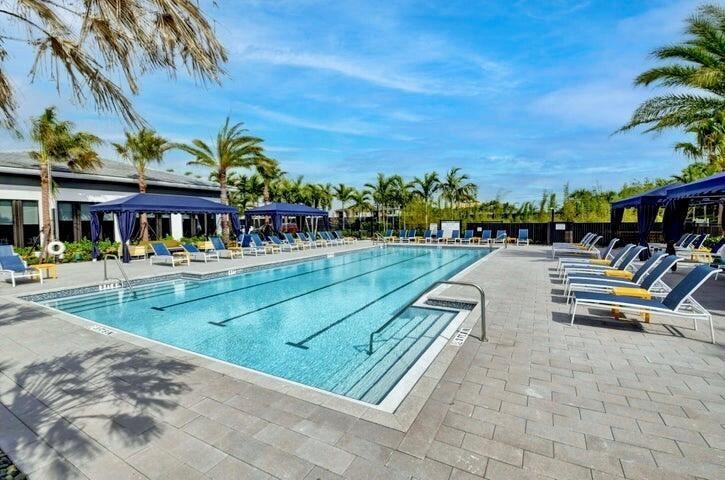 Resort-style community pool surrounded by expansive deck space and lounge seating.
