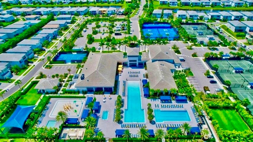 Aerial view highlighting the community layout, amenities, and surrounding landscape.