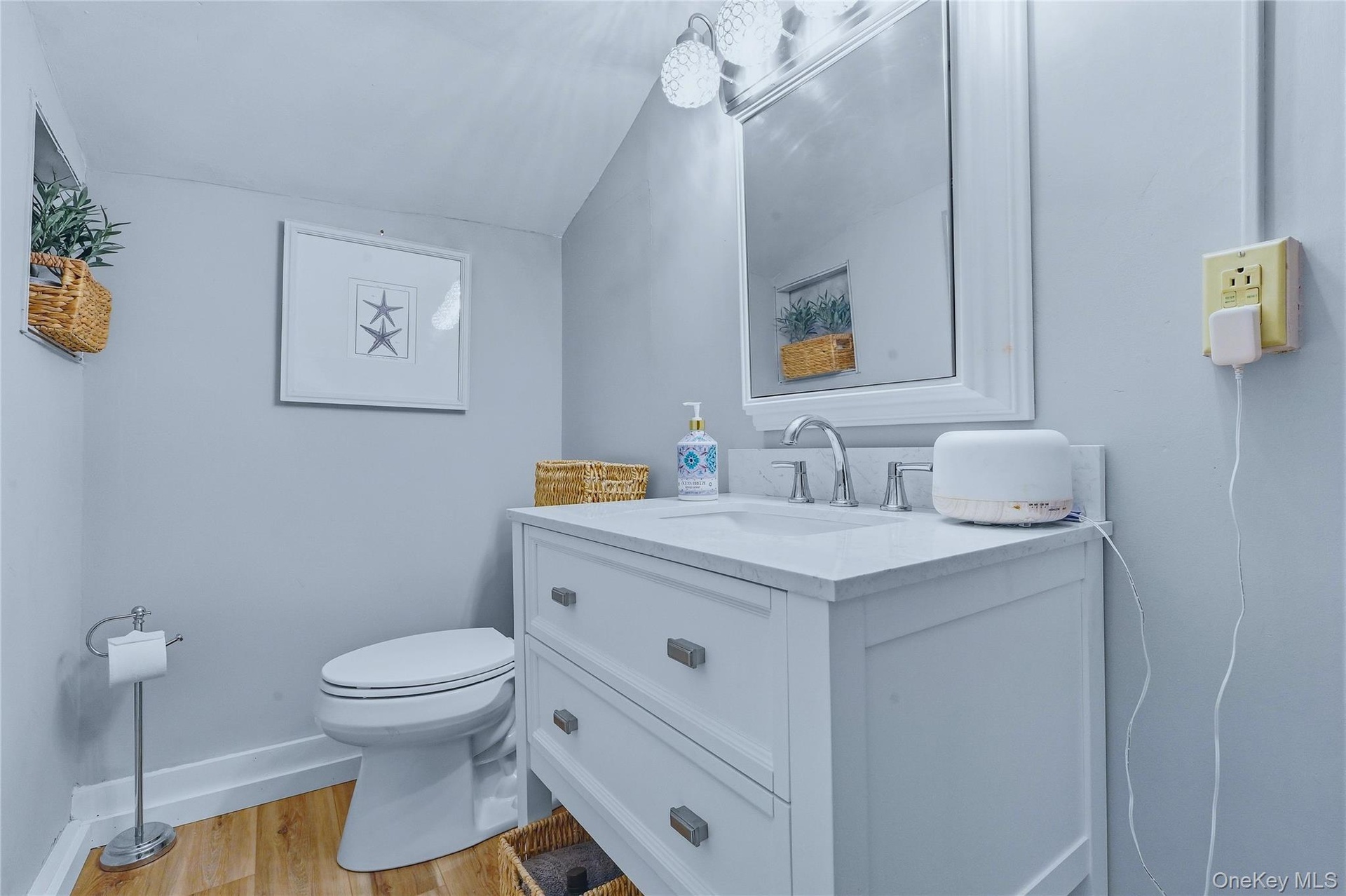 White vanity with a single basin sink, chrome faucet, and integrated countertop