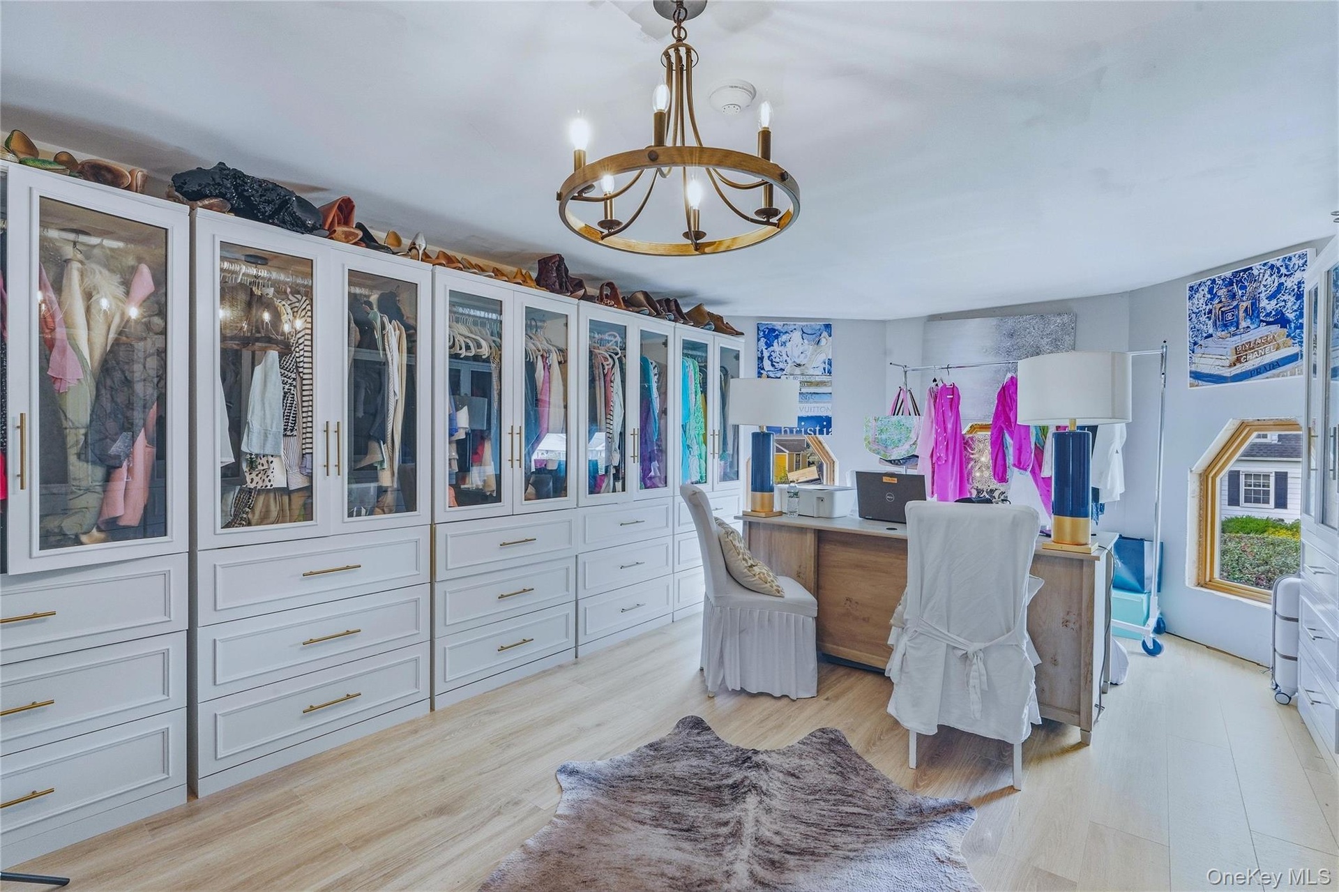 Custom built-in cabinetry with glass-front uppers, brass hardware, and ample drawer storage