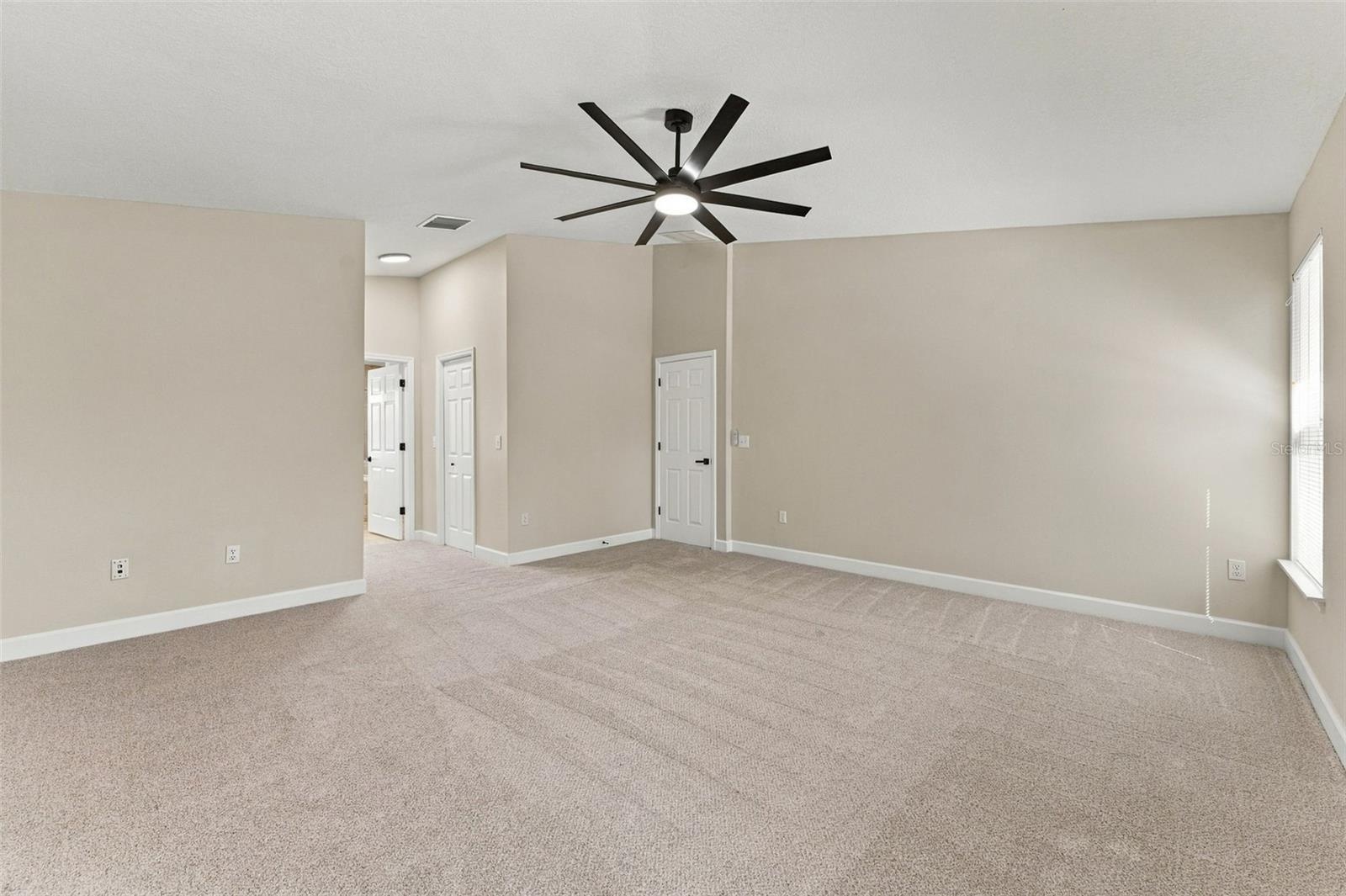 Very large primary bedroom with dual walk in closets
