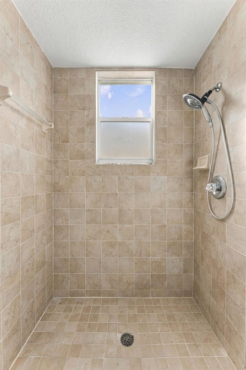 Large shower located in downstairs hall bathroom