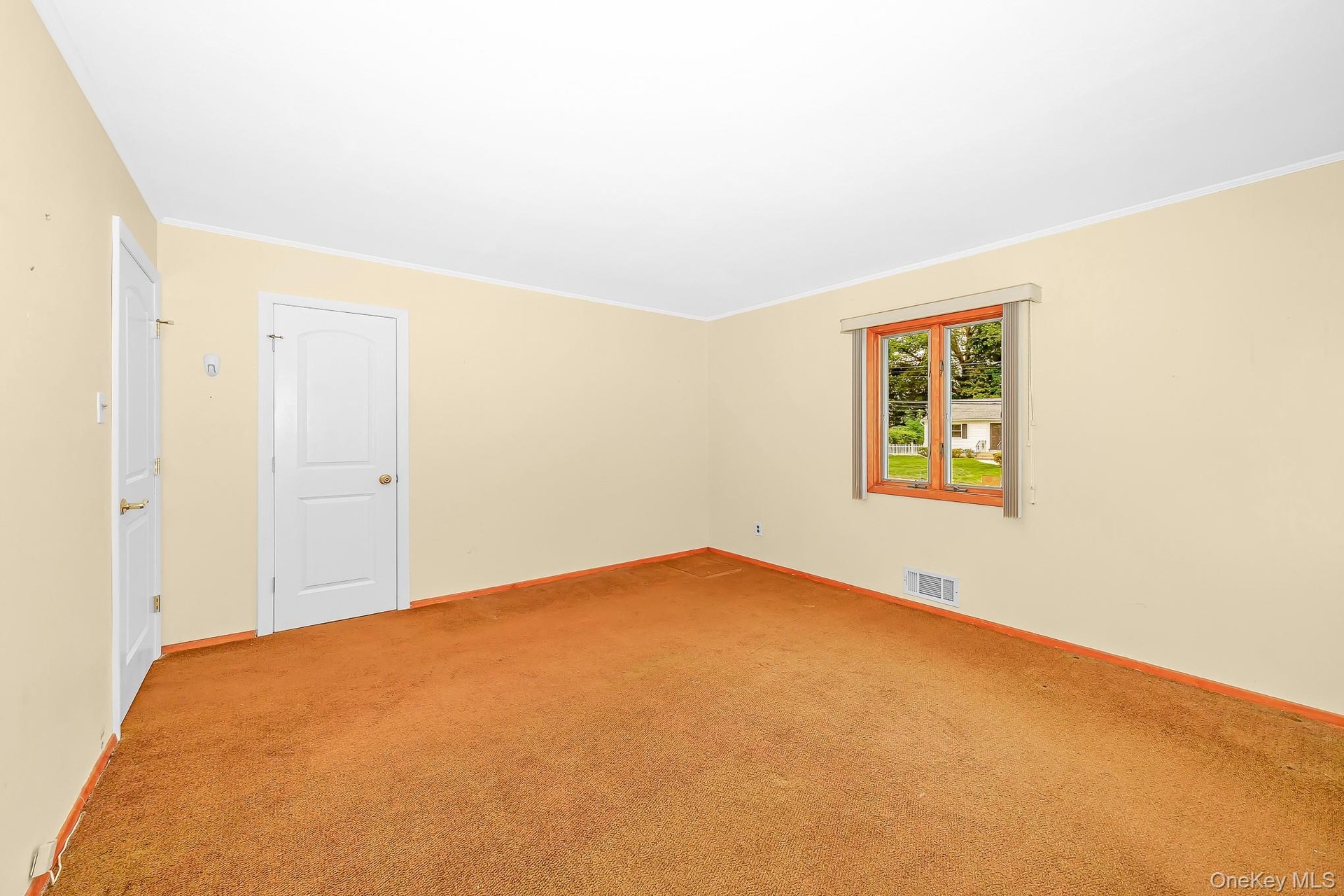 Primary bedroom carpeted. Hardwood under carpet