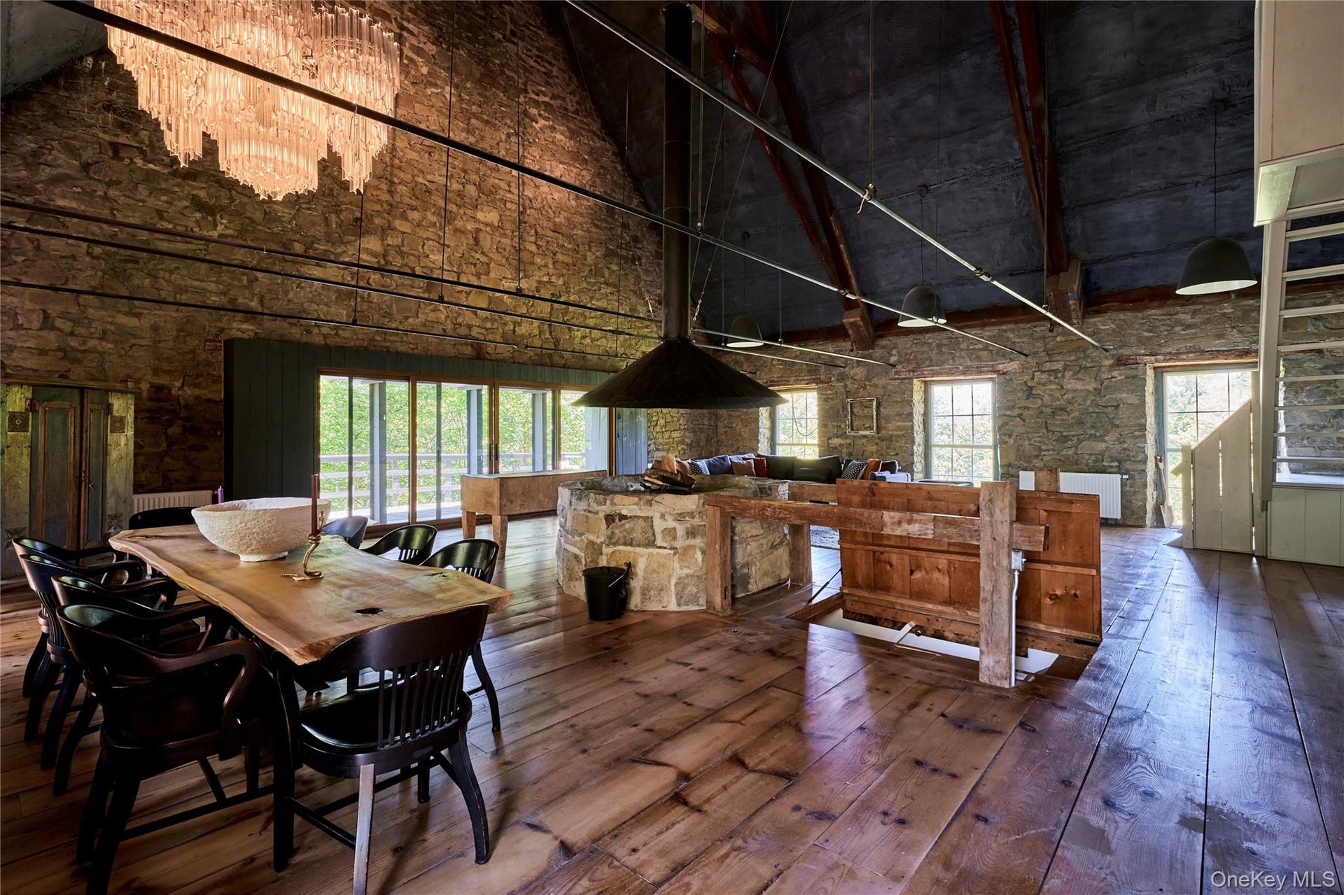 Dining space with hardwood / wood-style flooring, a high ceiling, and plenty of natural light