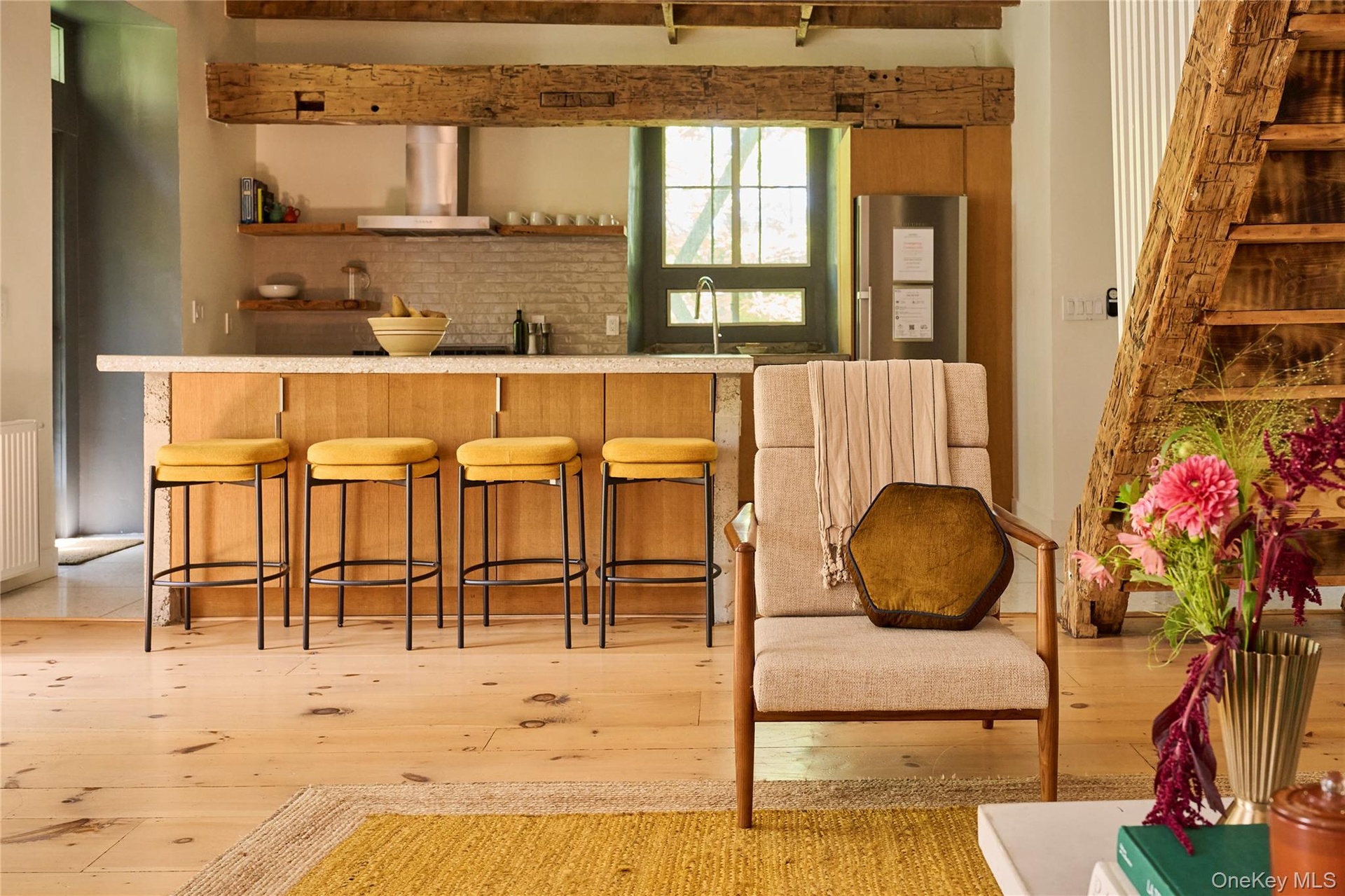 Bar area with open shelves, light countertops, wall chimney range hood, freestanding refrigerator, and light wood-type flooring
