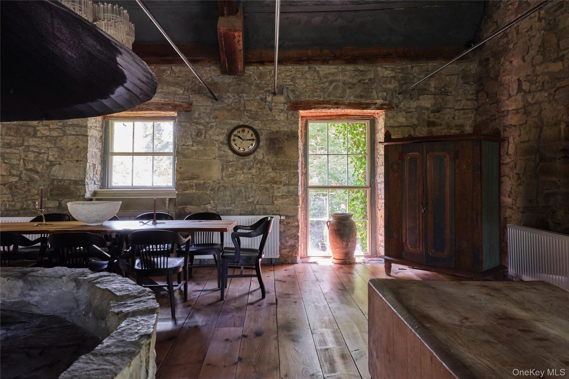 Dining area with hardwood / wood-style floors and radiator