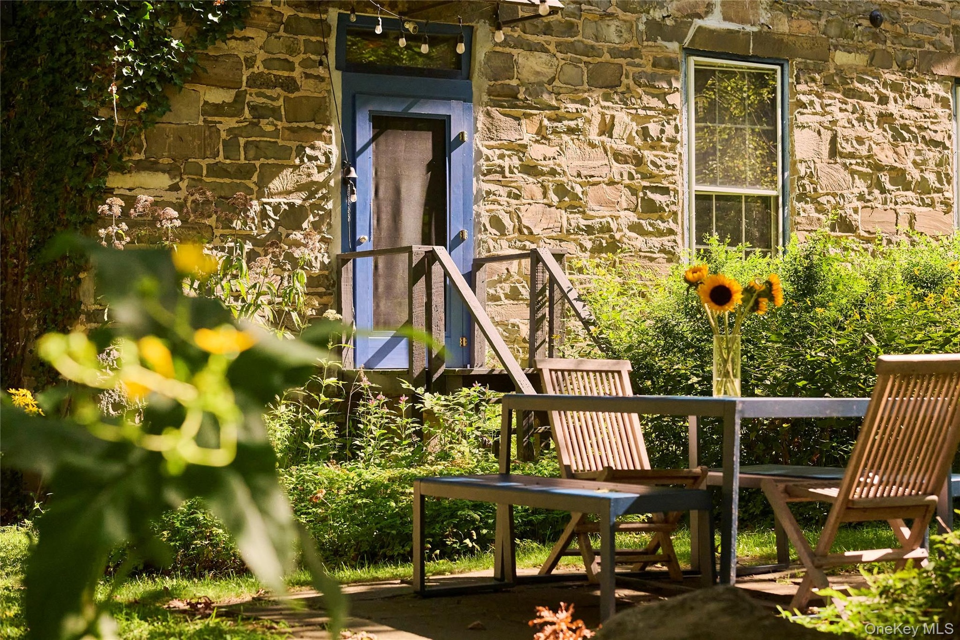 Doorway to property featuring stone siding