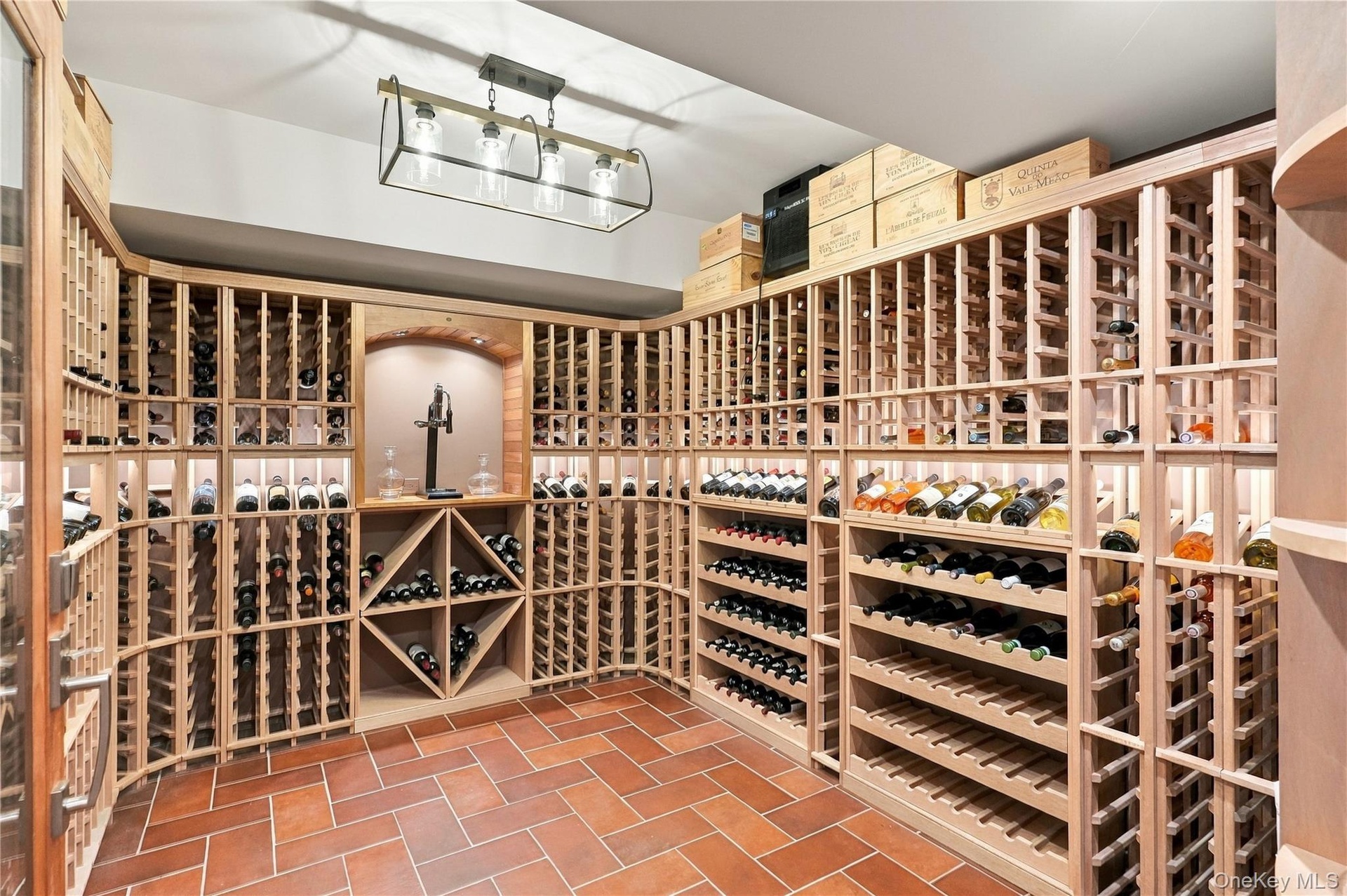 An impressive custom wine cellar with storage for approximately 1,200 bottles, complete with temperature and humidity control for ideal preservation a