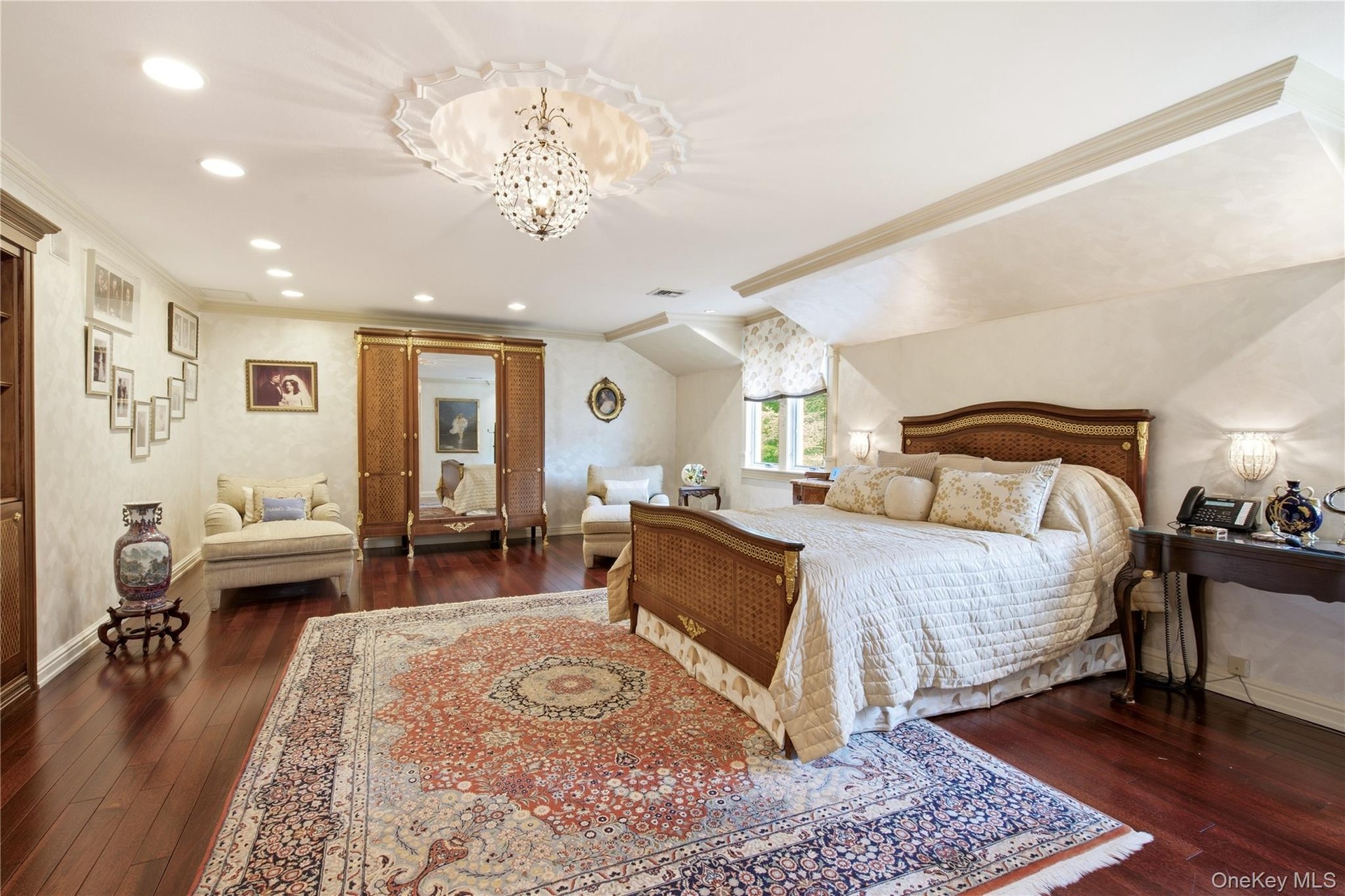 Expansive primary bedroom, featuring two custom outfitted closets, cherrywood flooring.